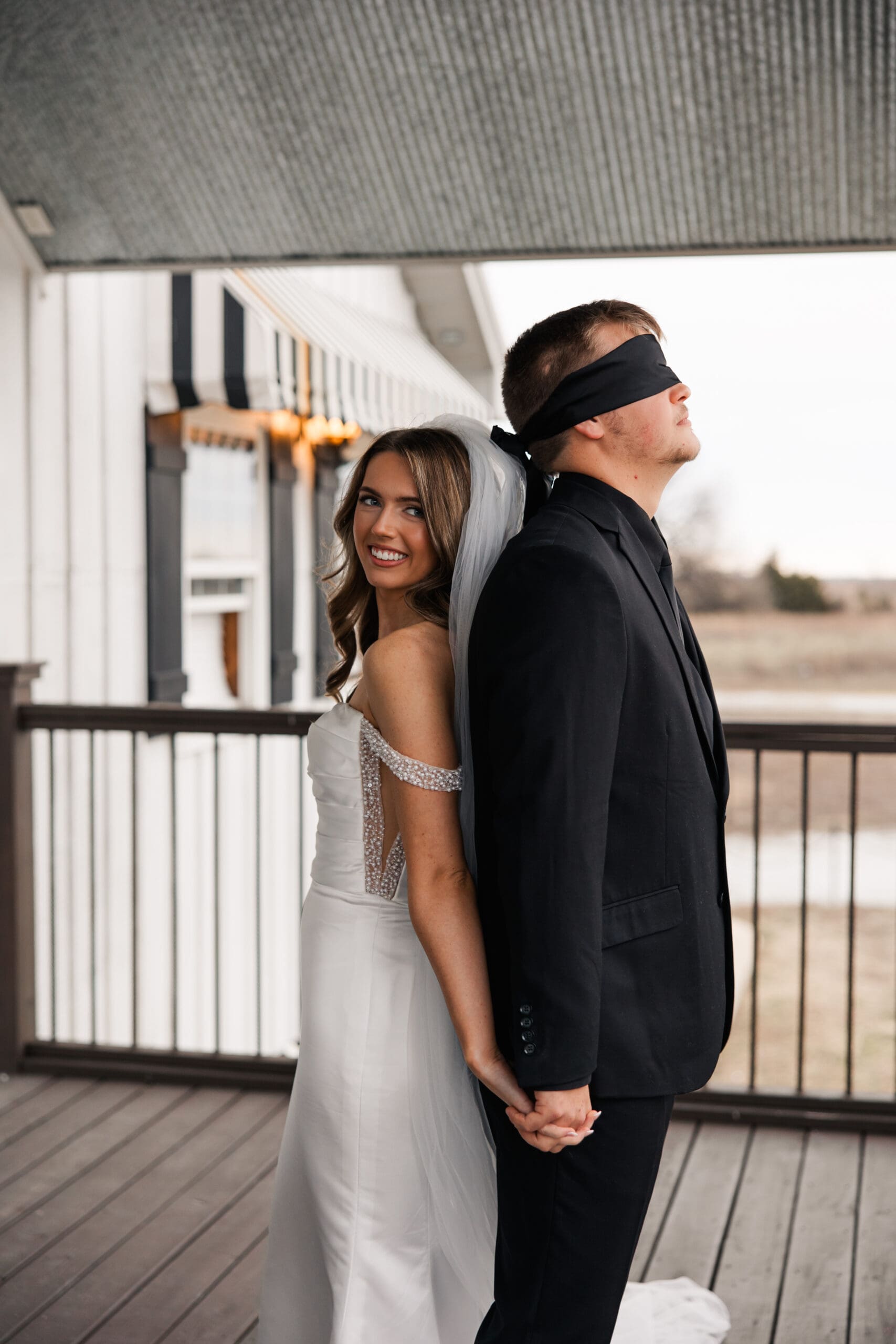 Emotional pre-ceremony prayer moment with bride and blindfolded groom at The Silver Spoon Barn