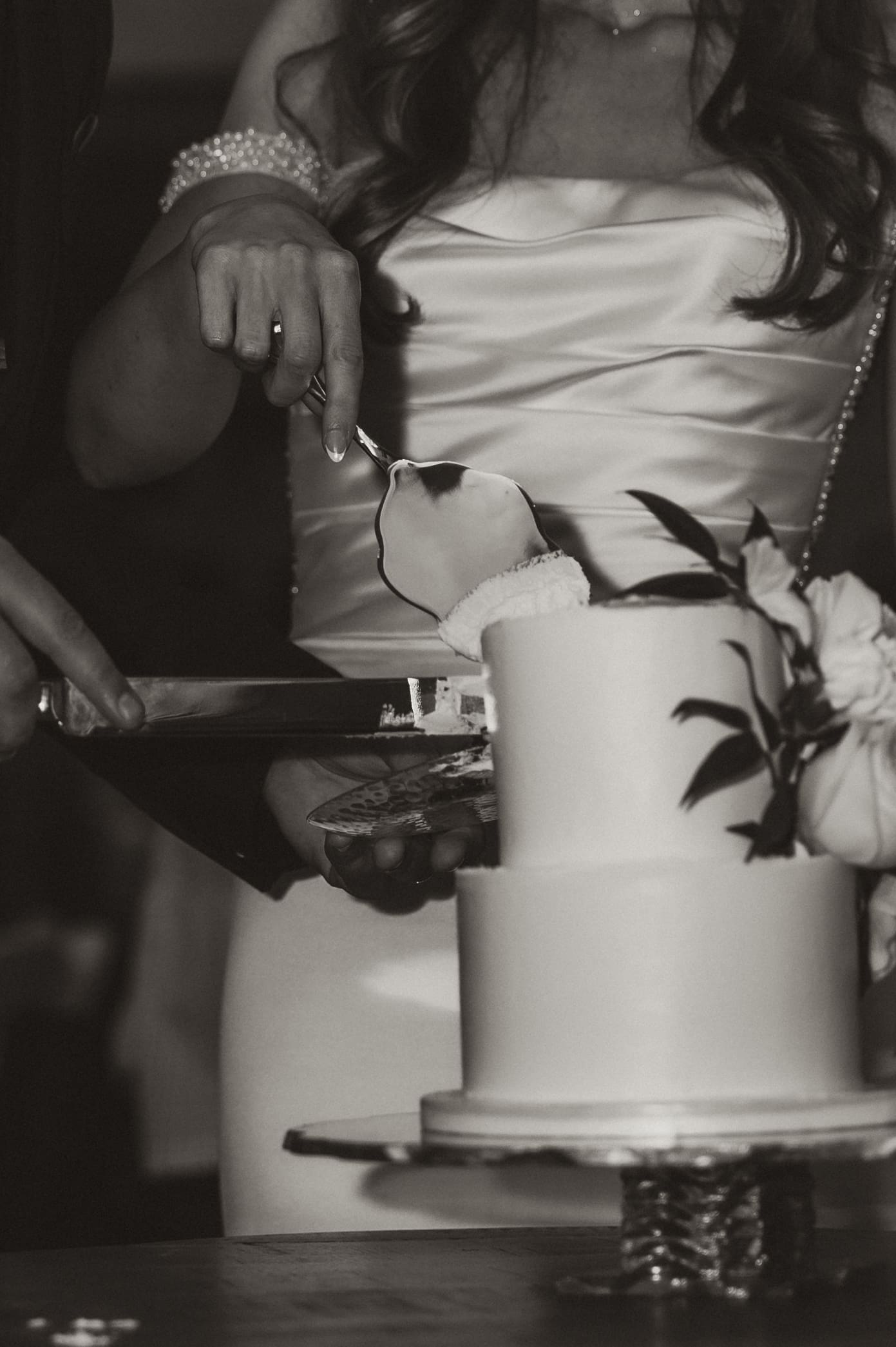 Bride and groom cutting their wedding cake during winter reception at The Silver Spoon Barn