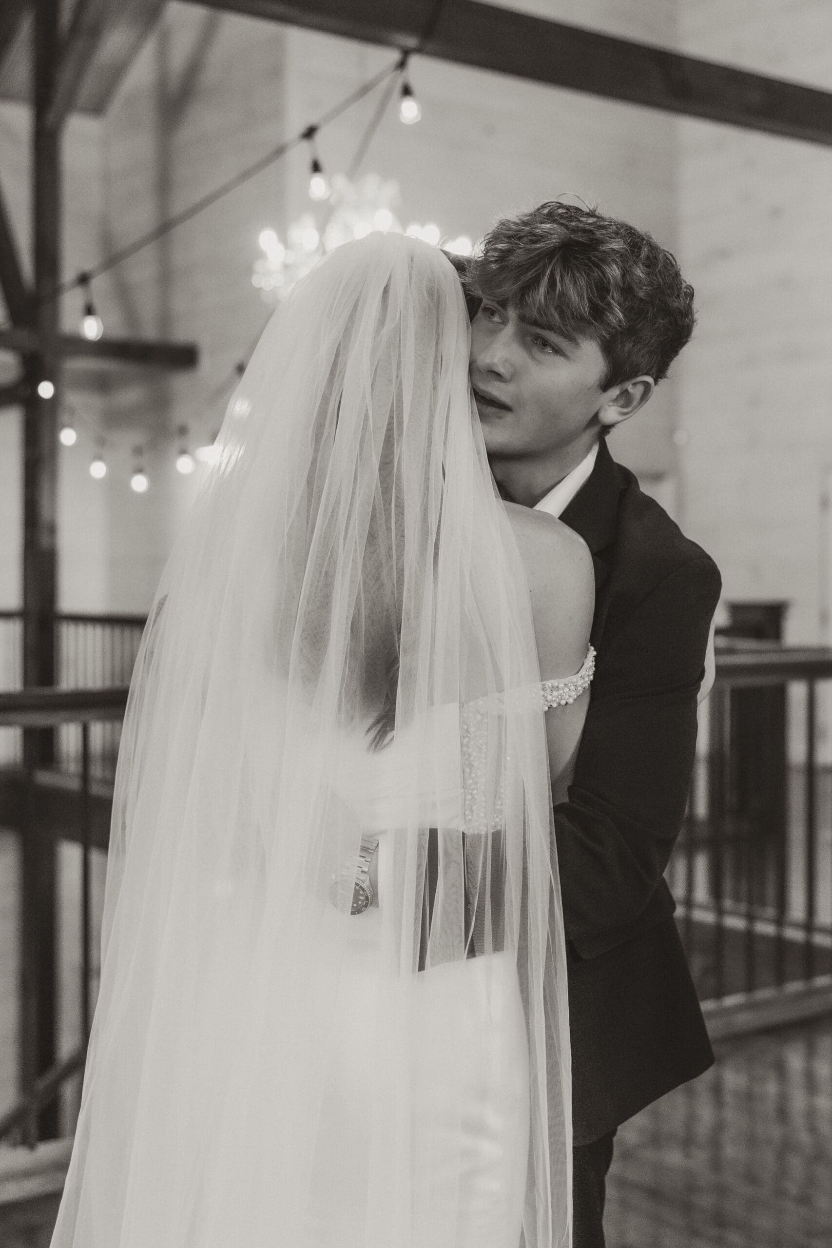 Bride hugging her brother during heartfelt first look before wedding ceremony