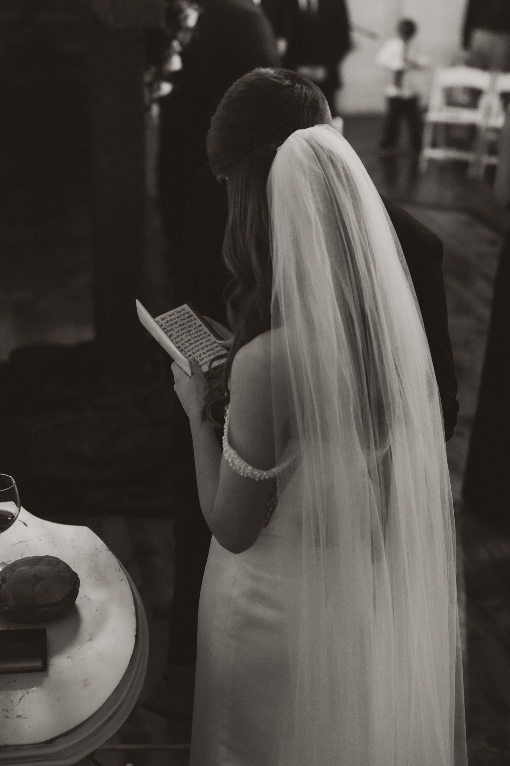 Bride and groom reading vows during indoor ceremony at The Silver Spoon Barn
