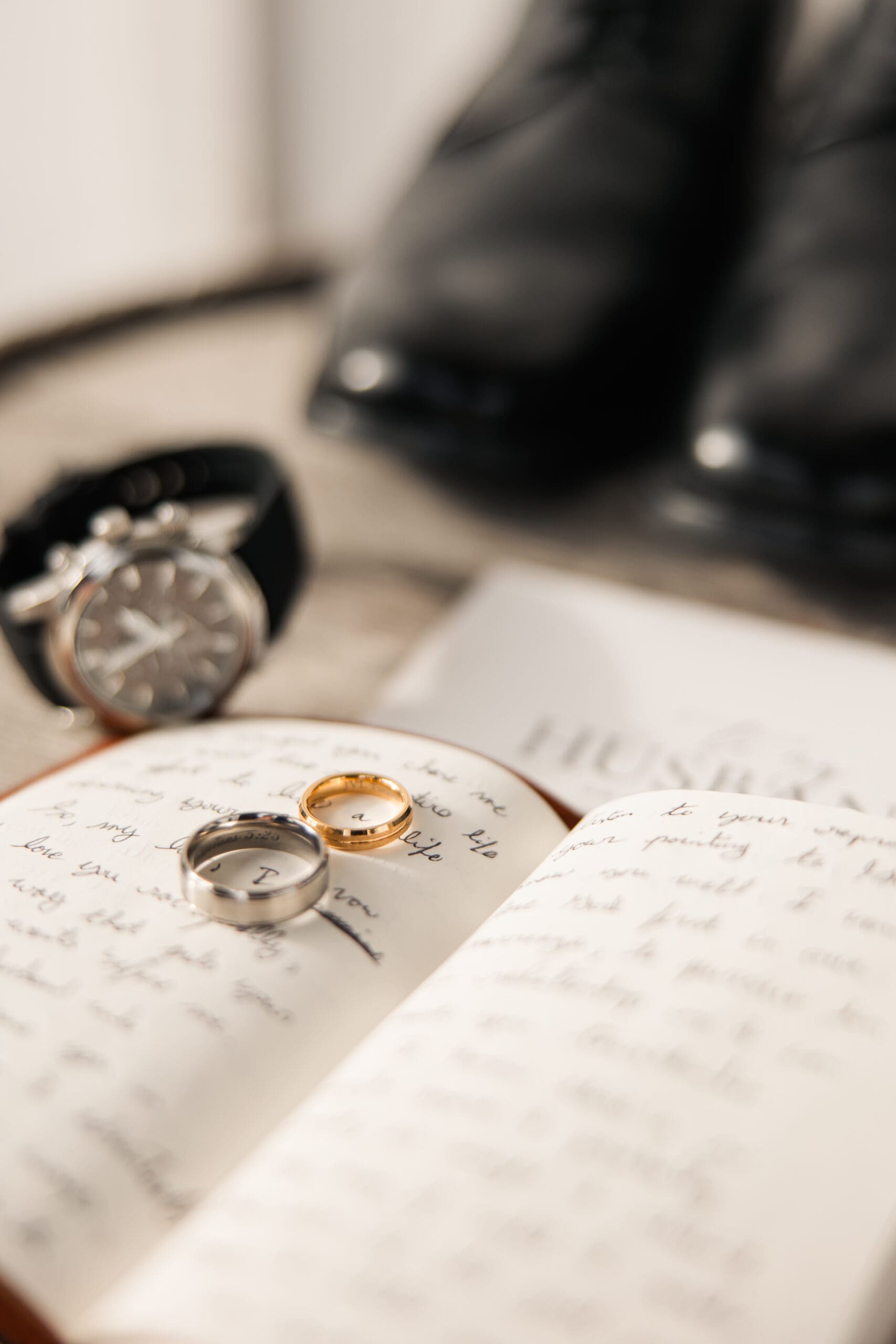 Wedding flatlay with rings, vow books, and winter details captured at The Silver Spoon Barn