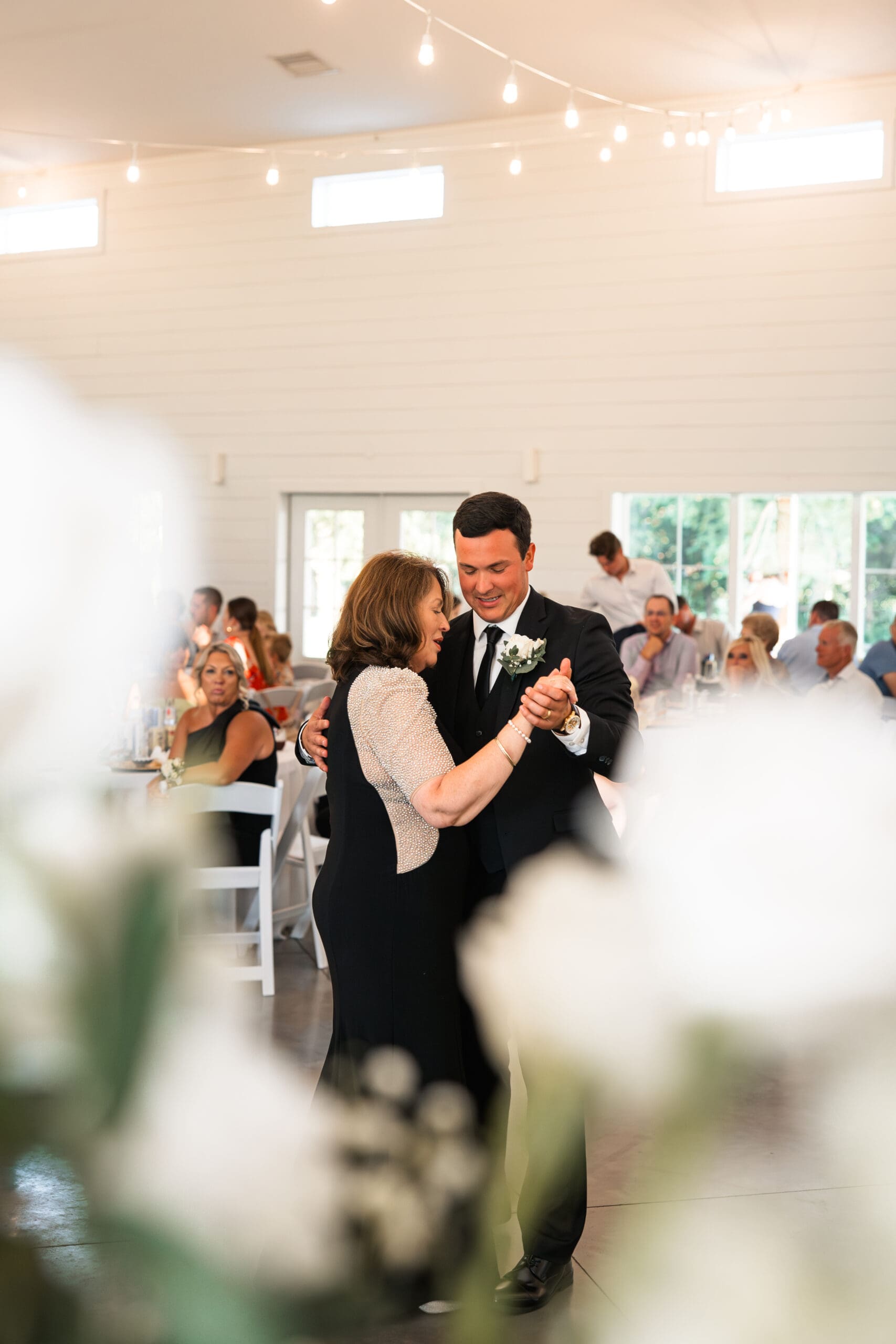 Groom and mother first dance Barn at Grace Hill wedding reception.