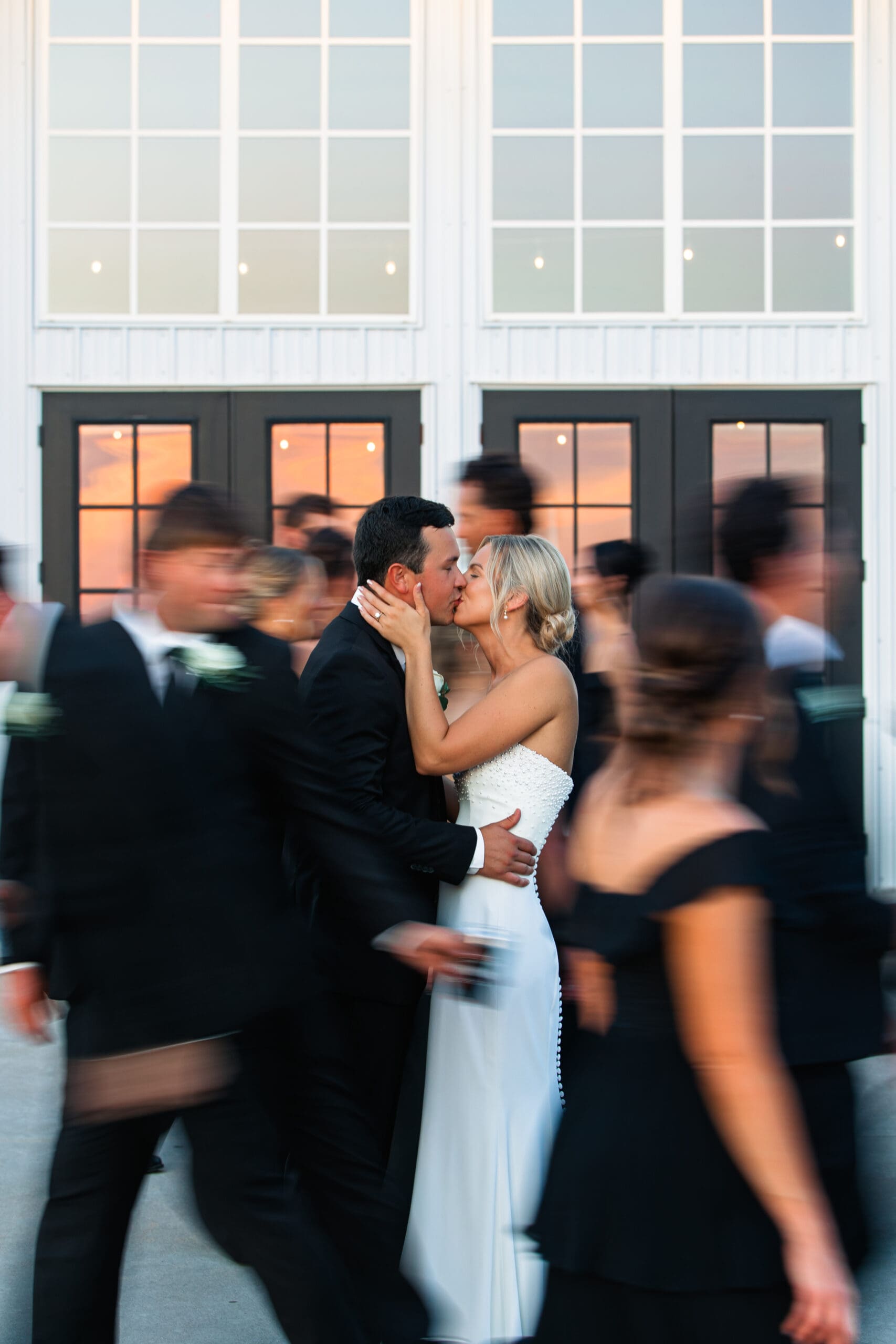 Bride and groom kiss during bridal portrait Barn at Grace Hill wedding.