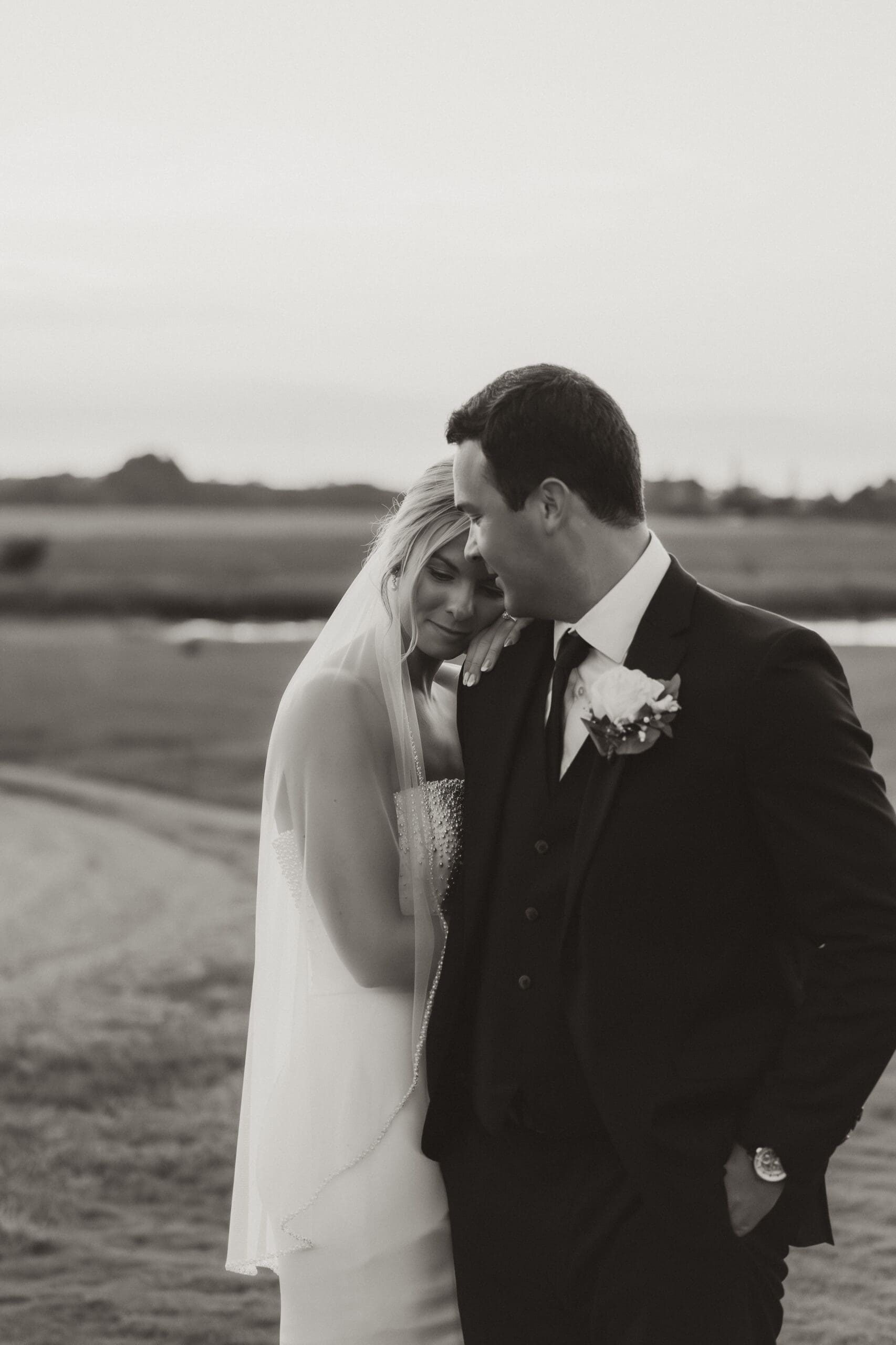 Bride resting head on groom’s shoulder Barn at Grace Hill wedding.