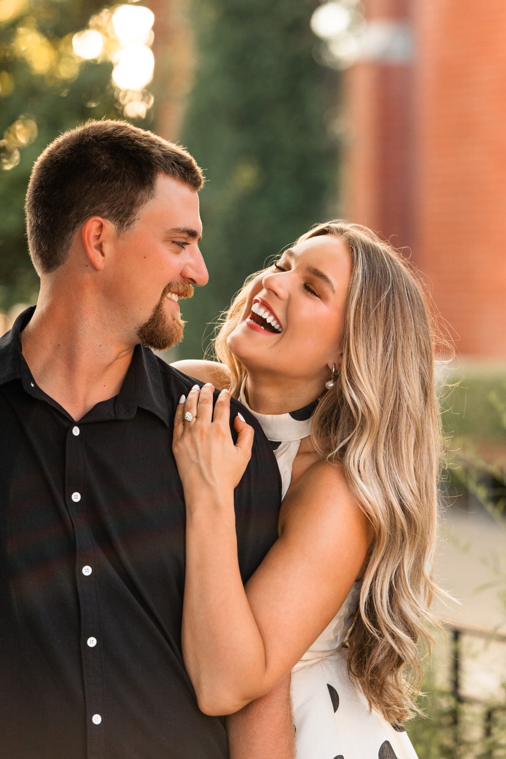 Bride throws head back laughing during candid moment. Wichita Wedding Photographer