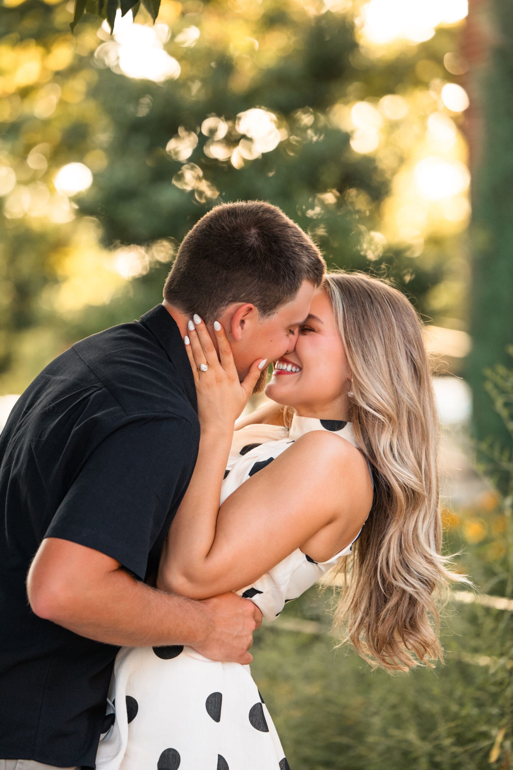 Bride and groom lean in for a kiss in the dreamy sunlight 