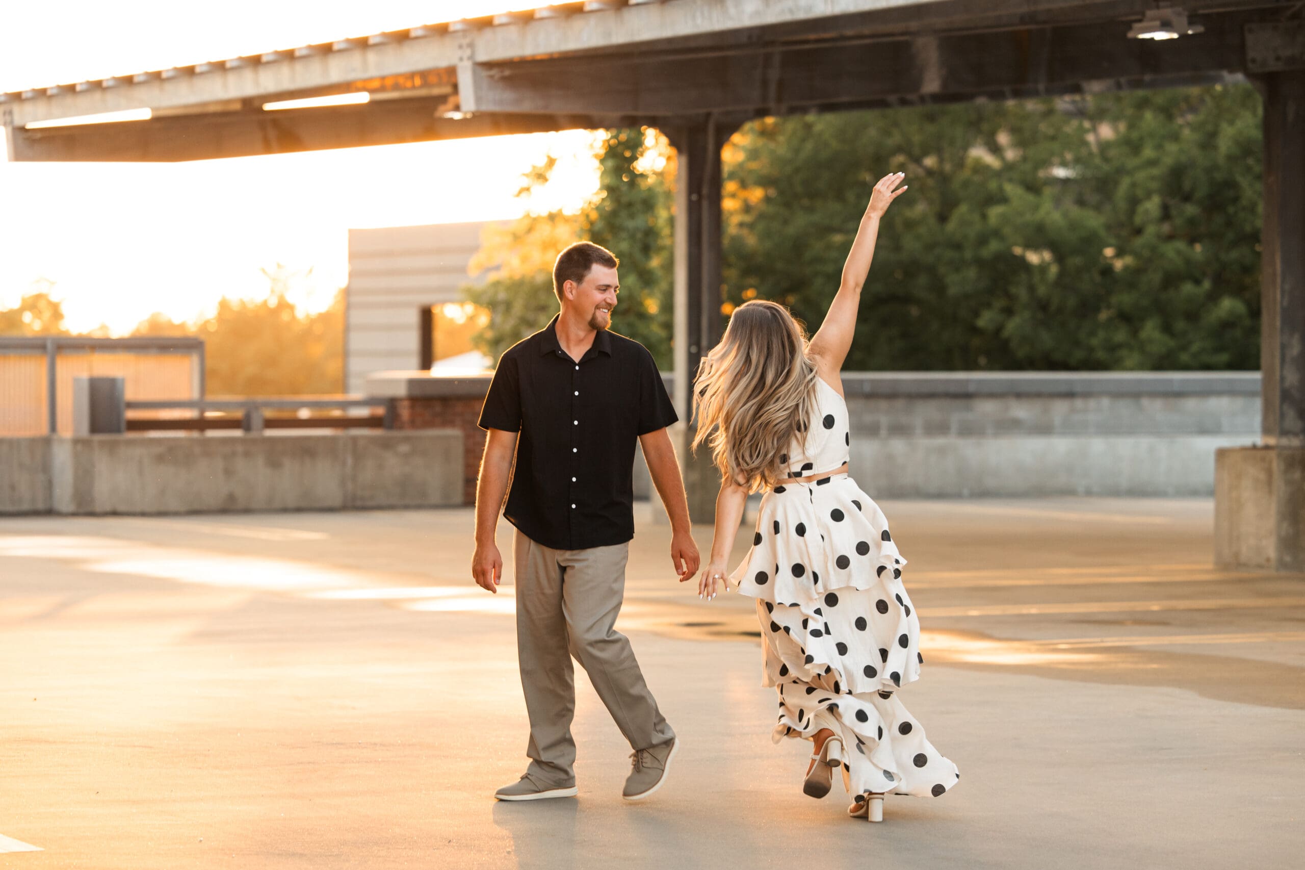The bride runs around the groom, laughing in a playful sequence.
