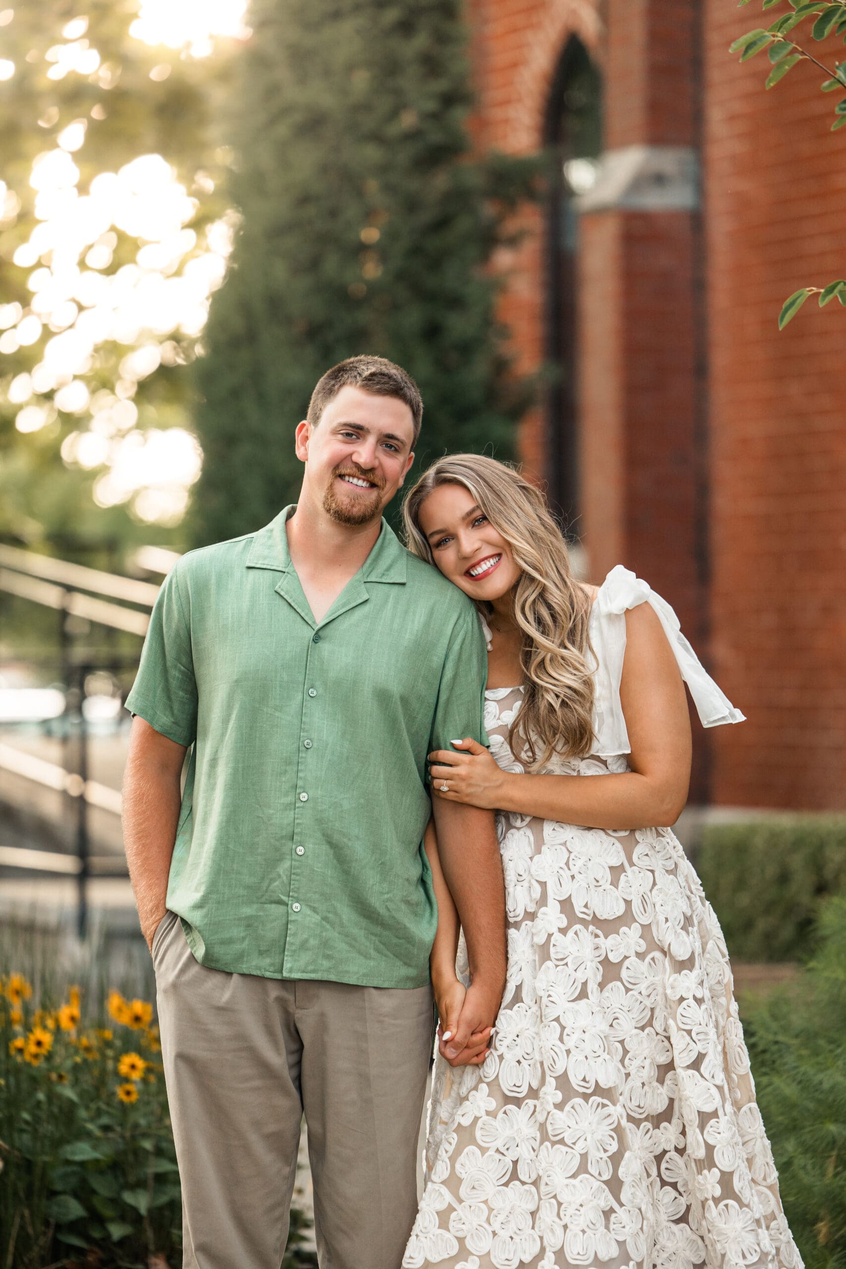 Bride and groom smile close together at the camera. Wichita Engagement Photographer