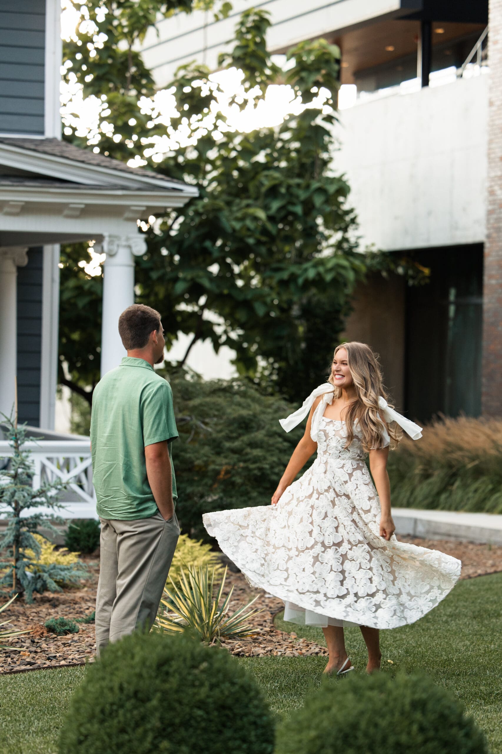 Groom admires bride as she twirls in her dress. Wichita Engagement Photographer