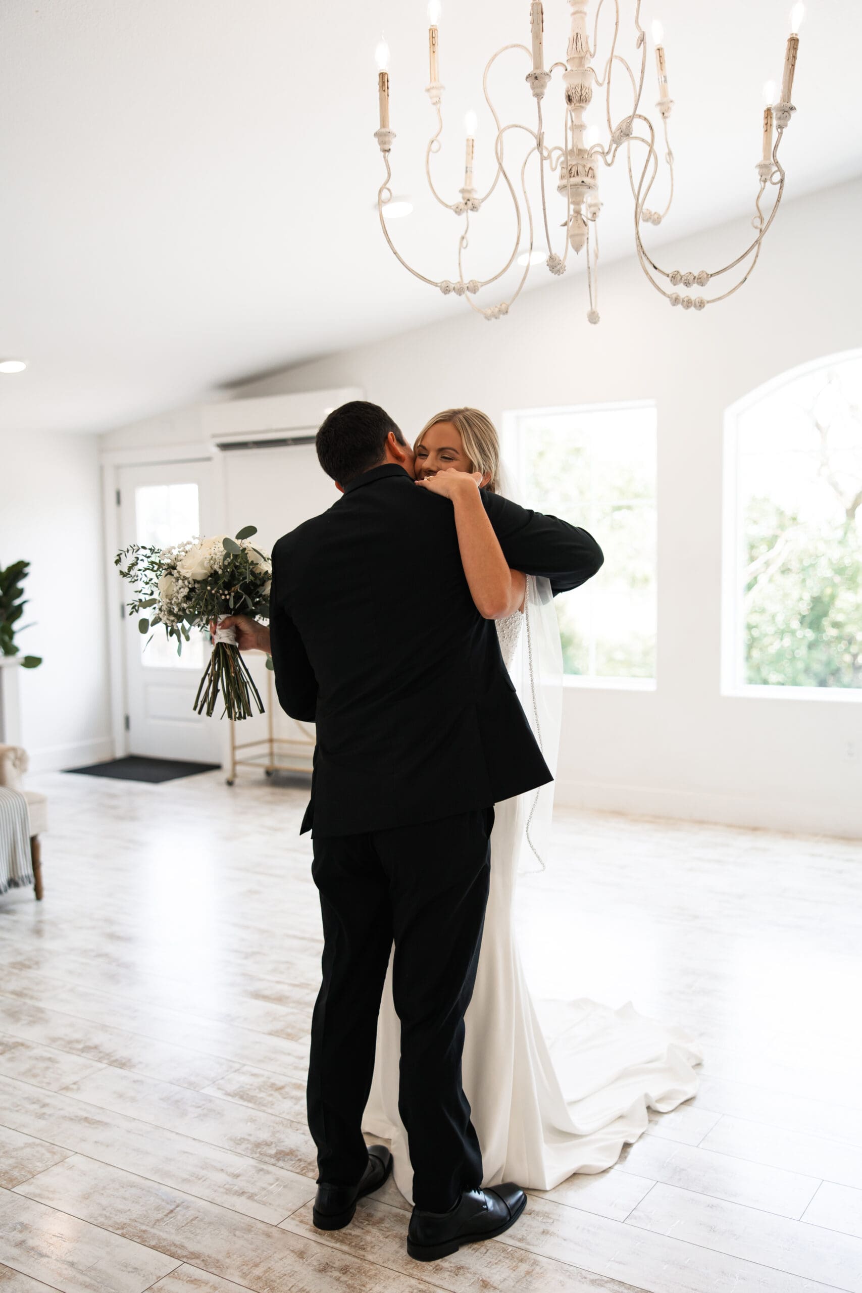 Bride hugging groom after first look Barn at Grace Hill.