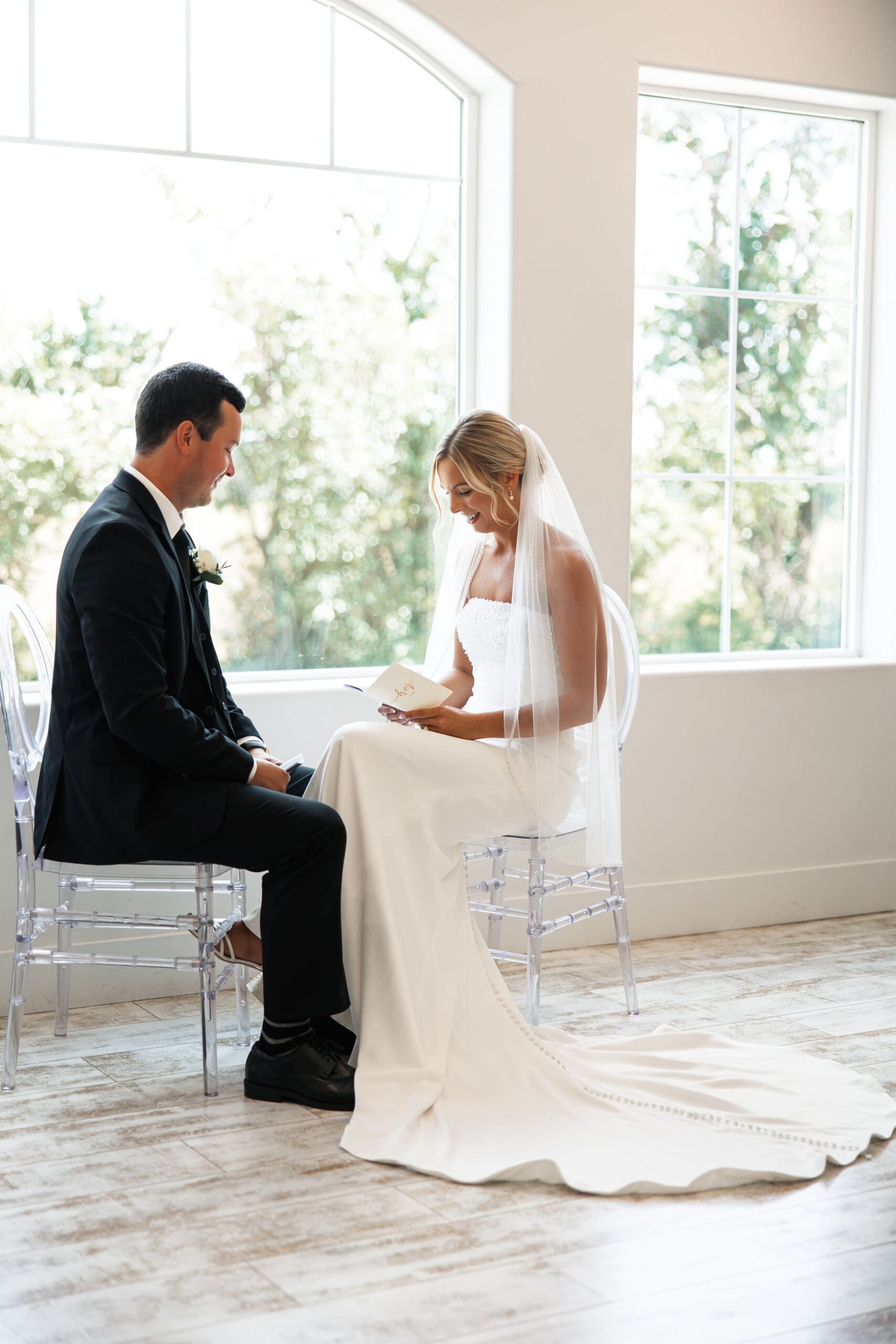 Bride and groom sitting down sharing vows Barn at Grace Hill wedding.