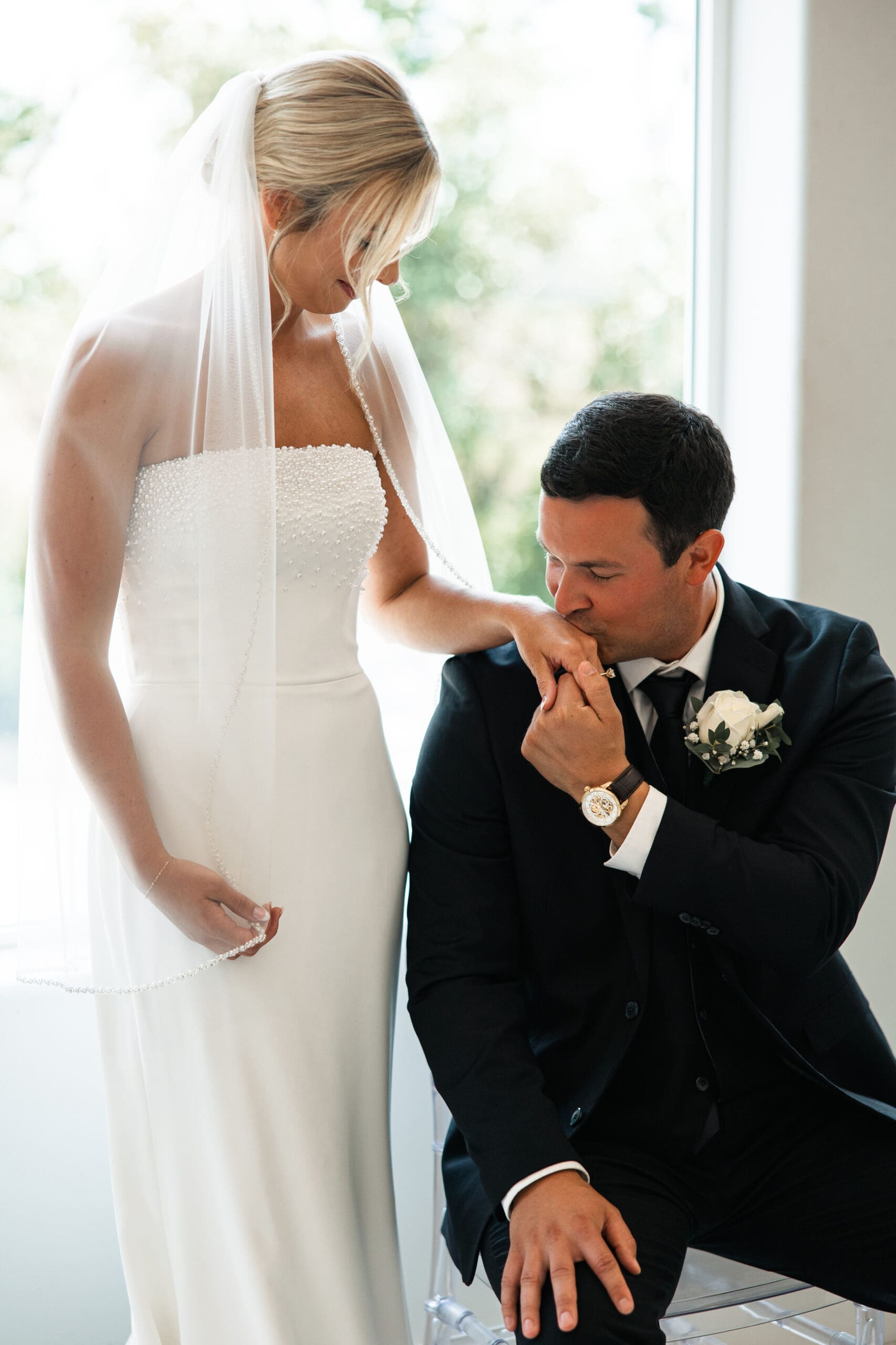Groom kissing bride’s hand Barn at Grace Hill wedding.