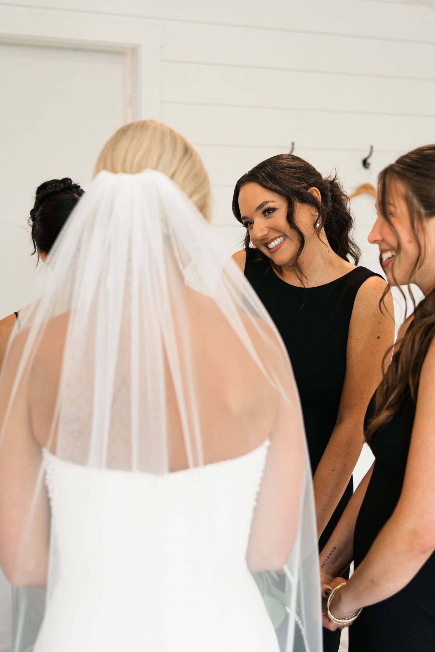 Bride’s first look with bridesmaids Barn at Grace Hill wedding.