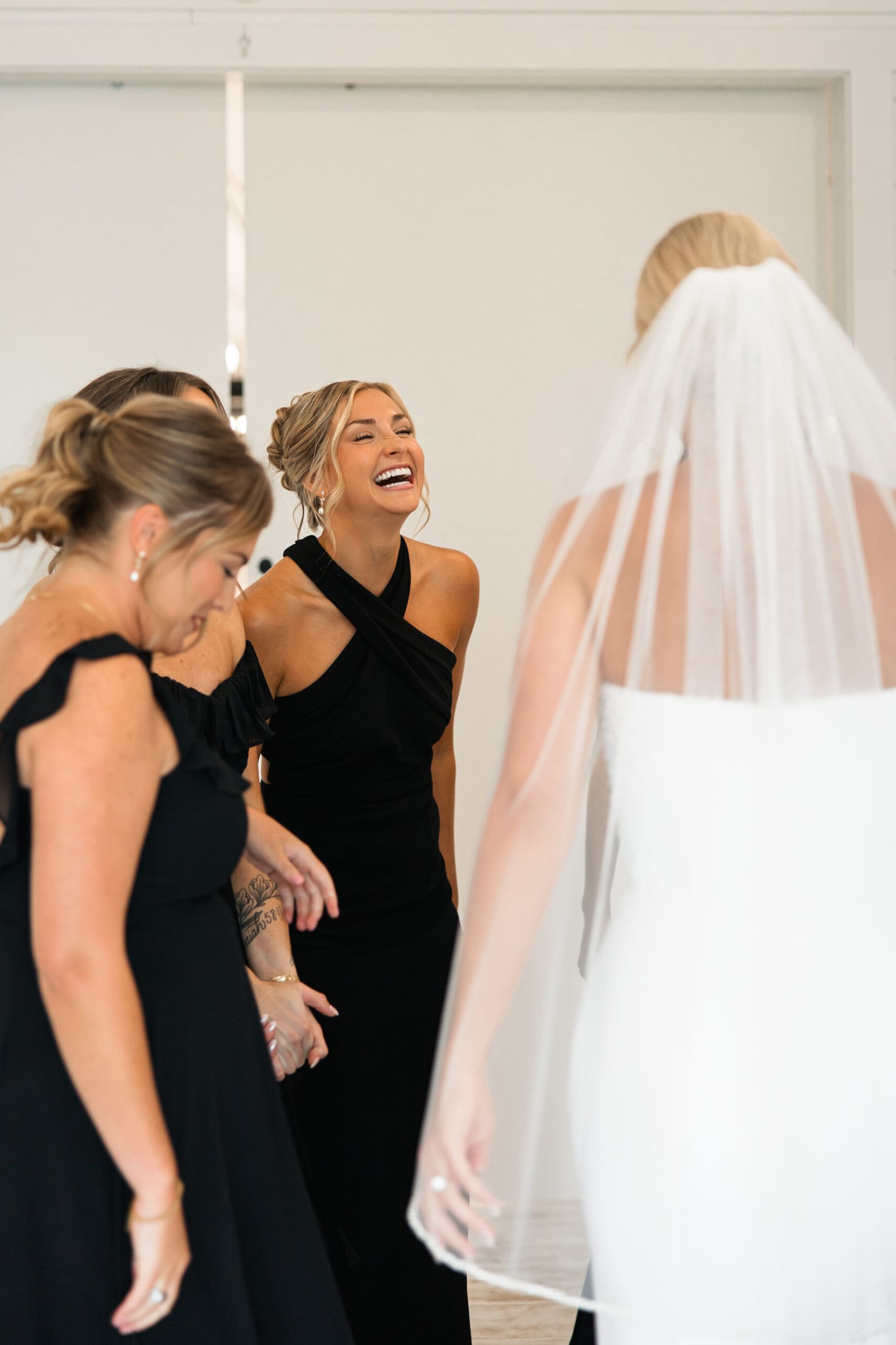 Bride laughing with Maid of Honor Barn at Grace Hill wedding.