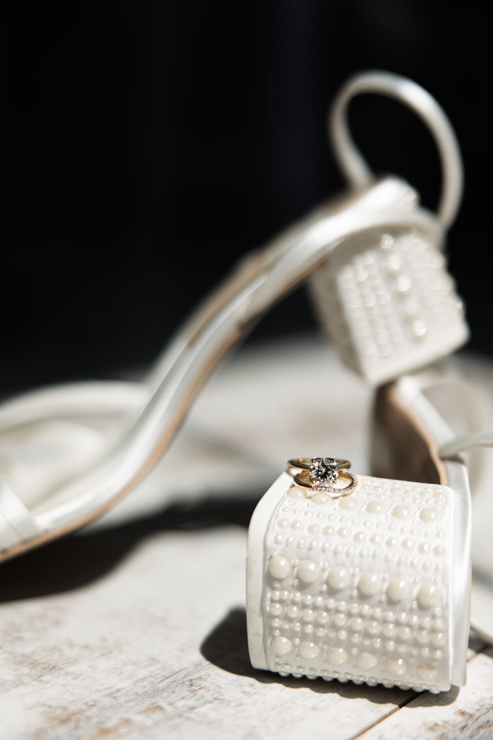 Bride’s rings and shoes detail photo 