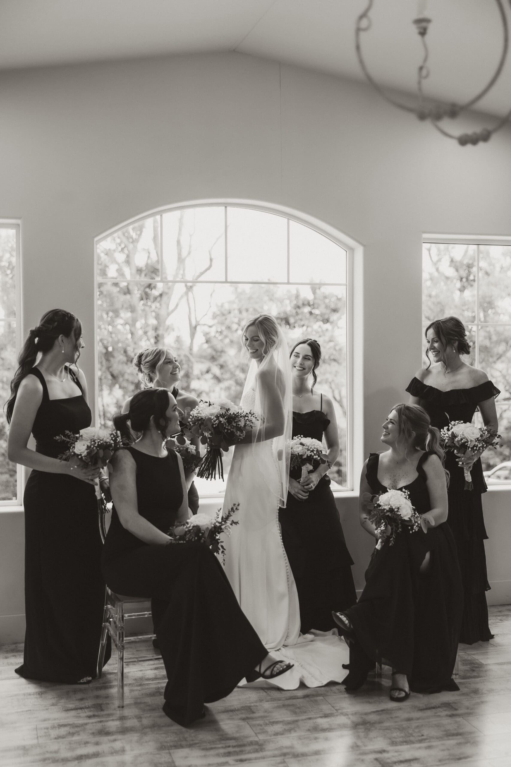 Bride standing with bridesmaids smiling Barn at Grace Hill wedding.