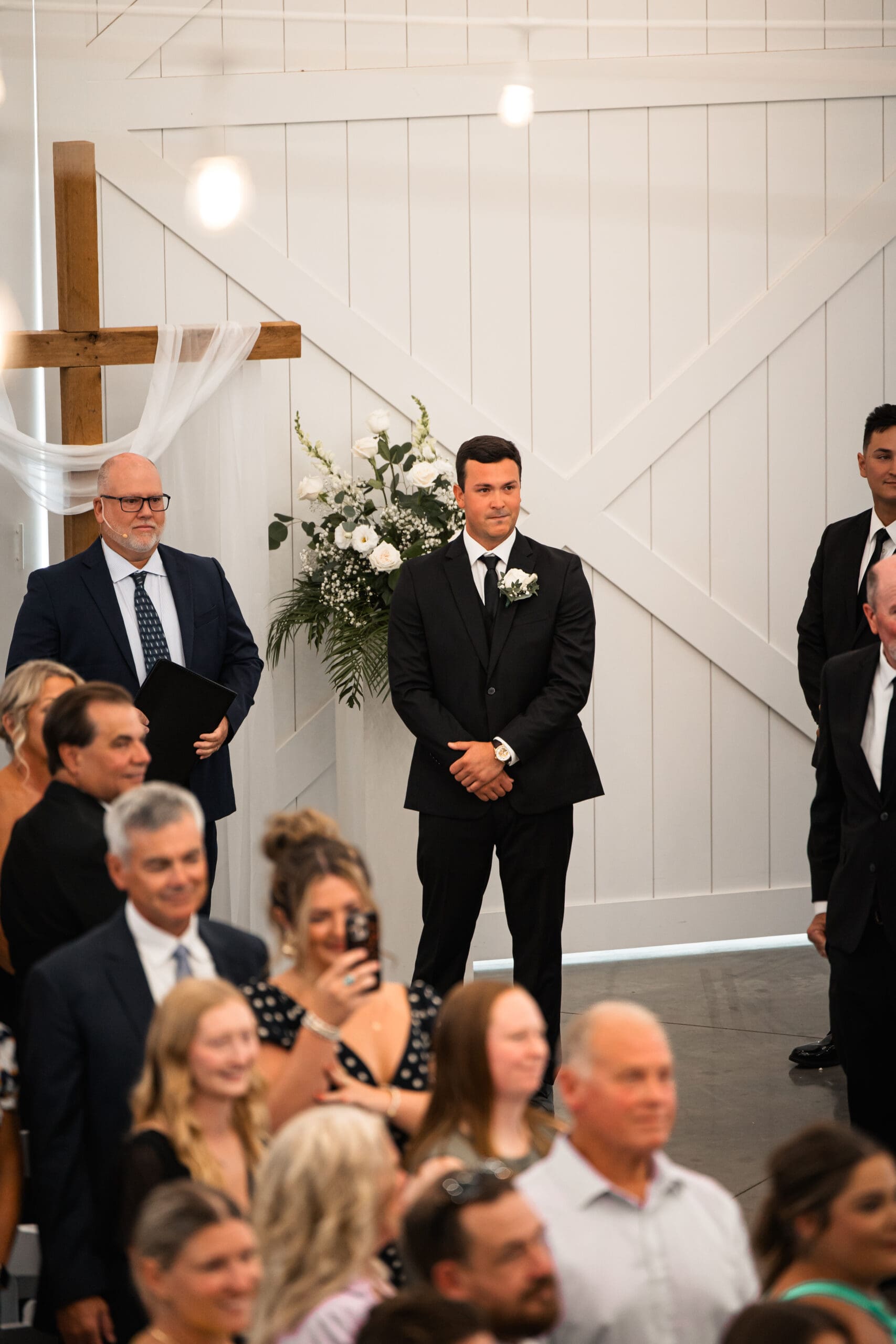 Groom tearing up watching bride walk down aisle Barn at Grace Hill.