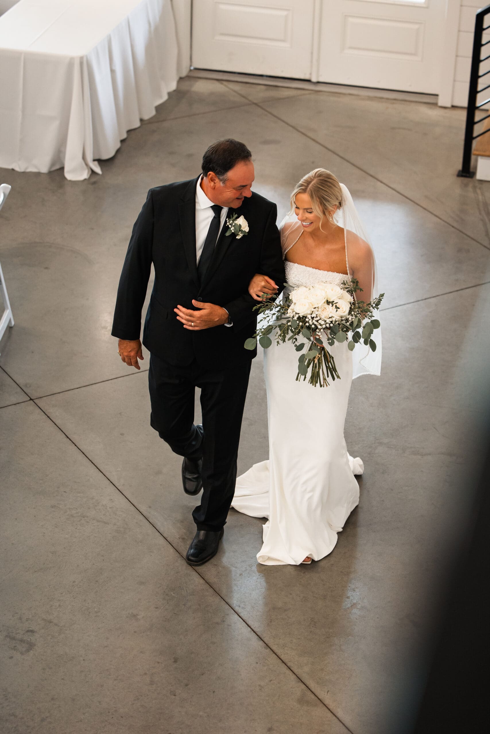 Bride walking down aisle with dad Barn at Grace Hill wedding.