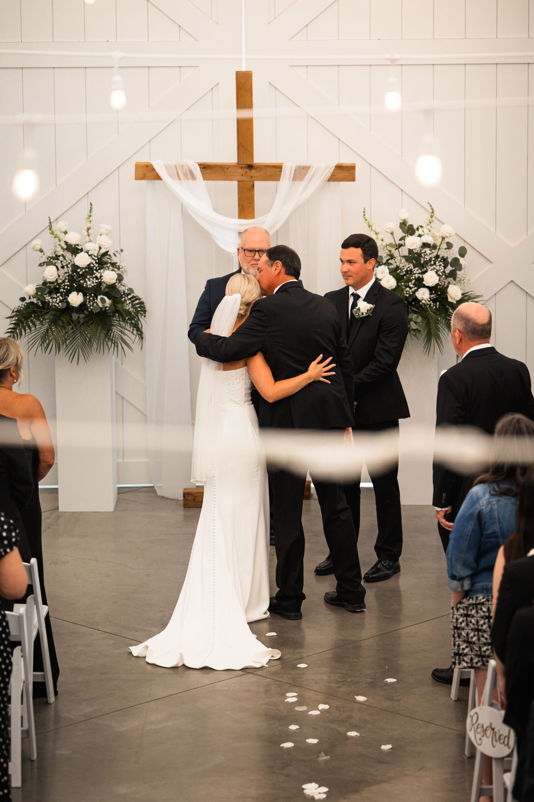 Bride’s dad kissing her forehead before handing her off Barn at Grace Hill.