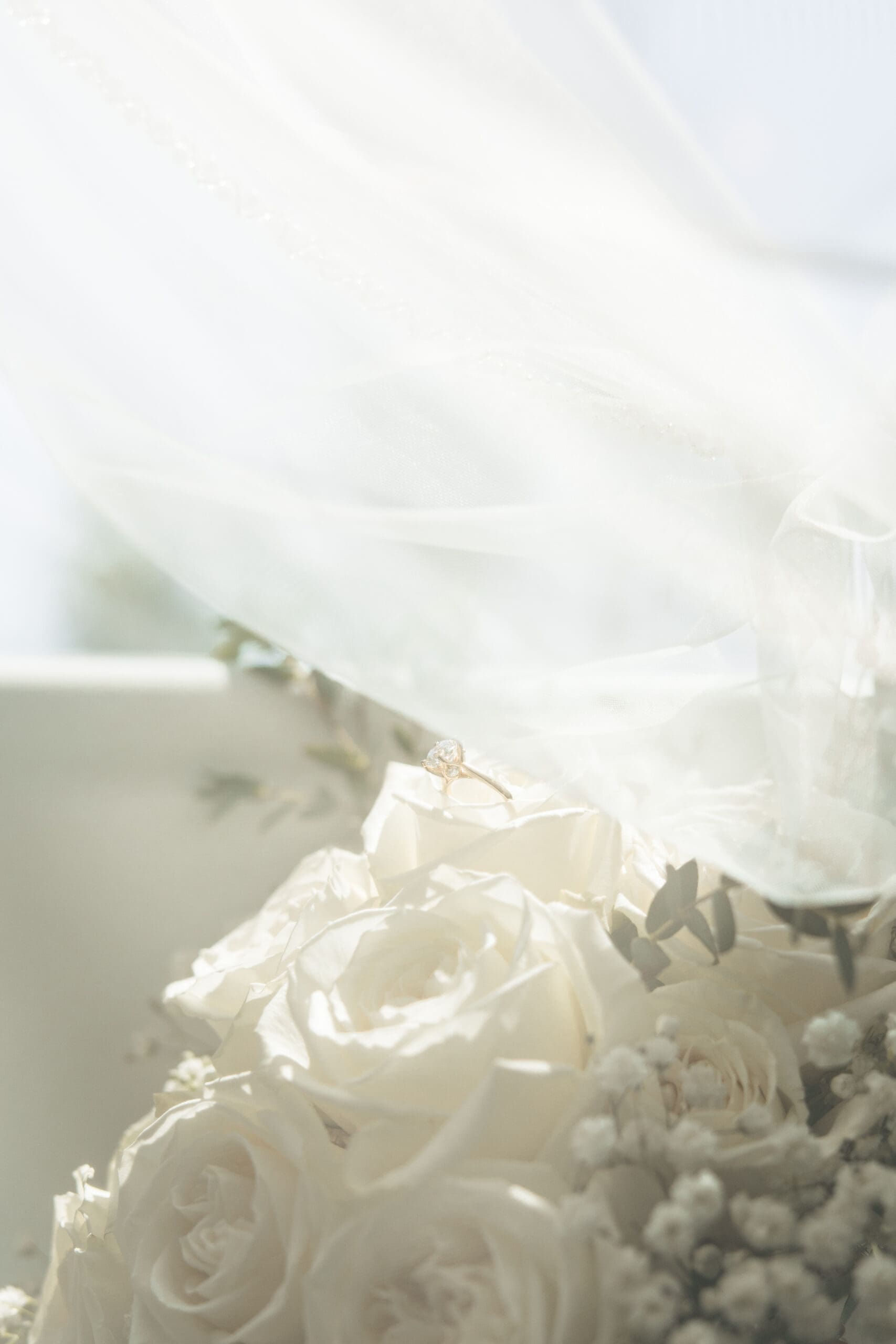 Wedding ring shot under bride’s veil