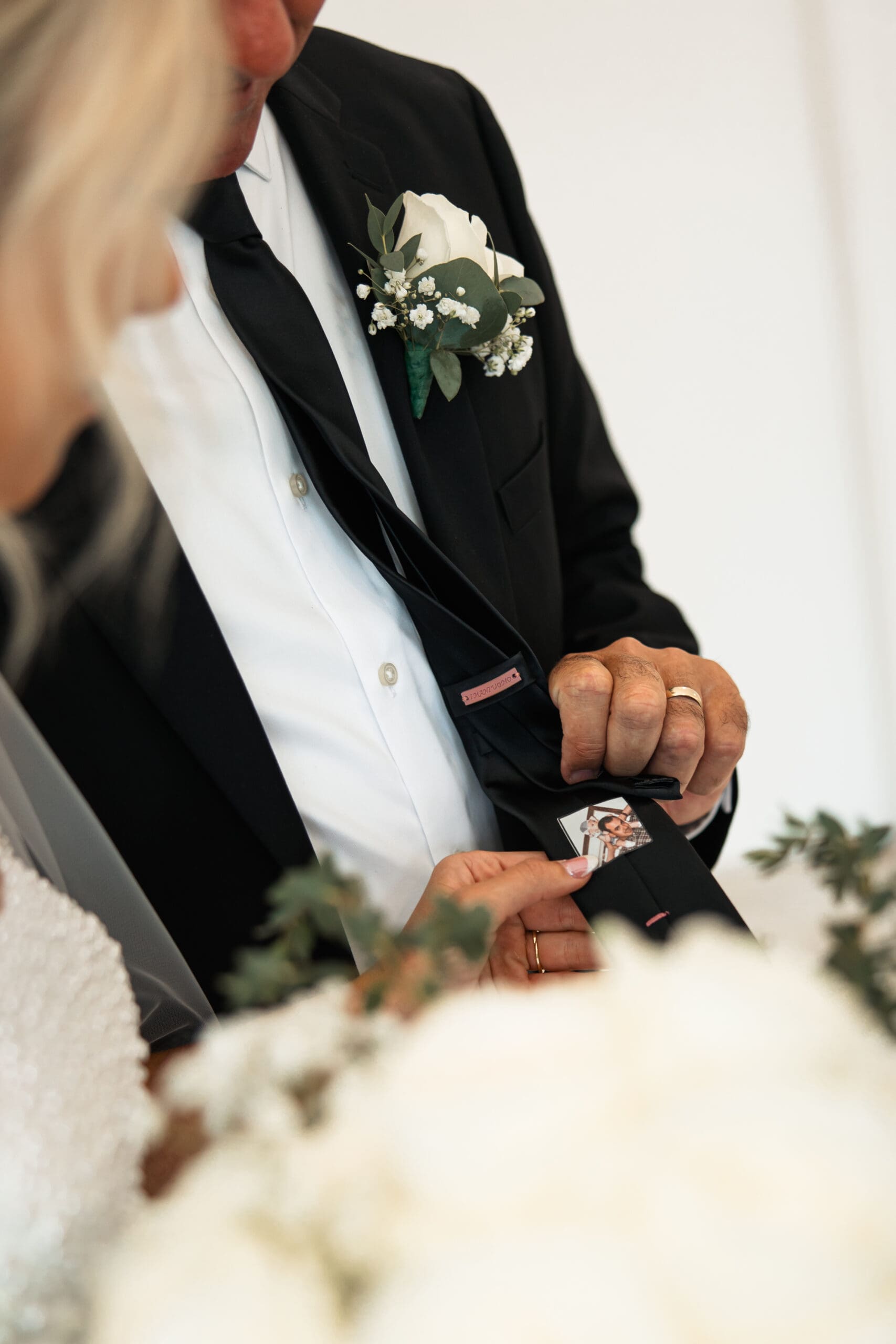 Bride’s dad showing tie photo of daughter as child Barn at Grace Hill wedding.