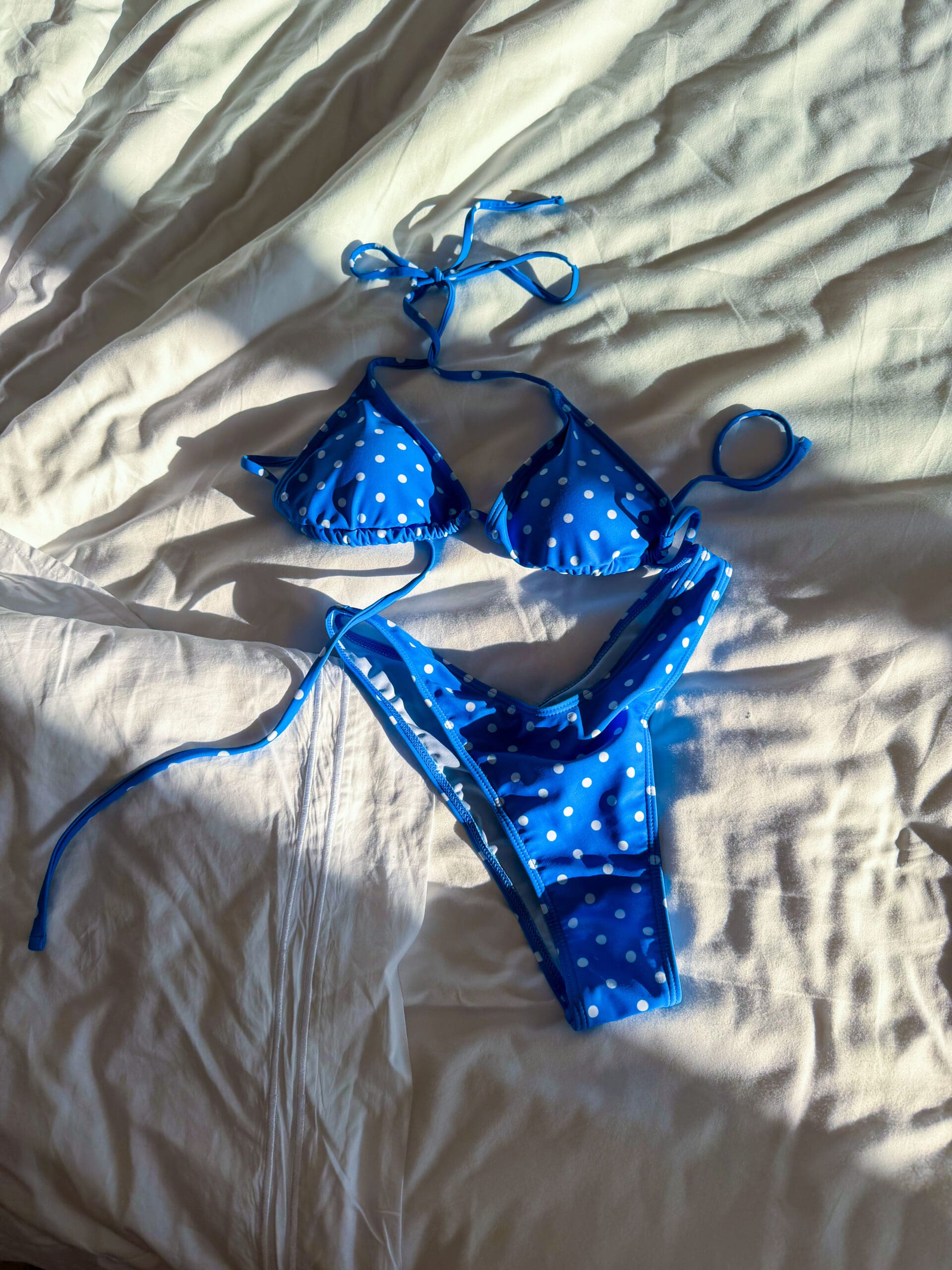 Swimsuit laid out on bed at Haven Riviera Cancun honeymoon suite