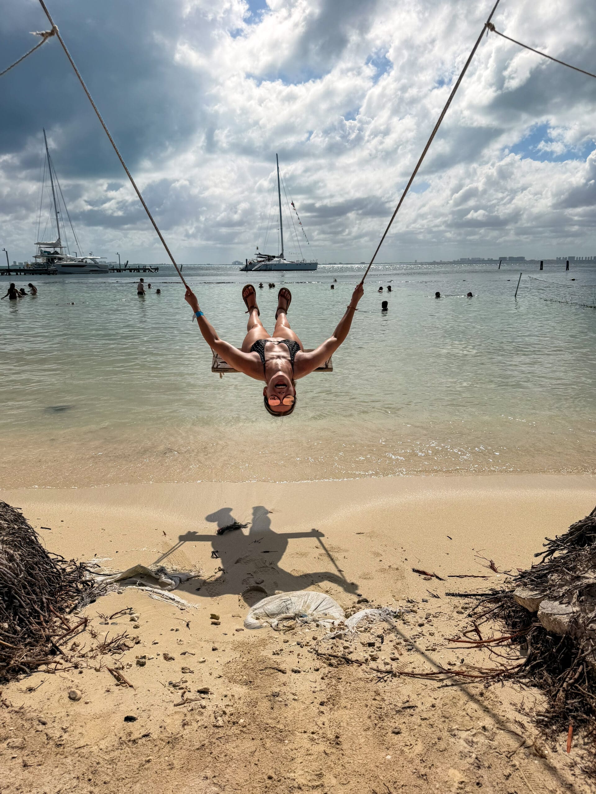 Swinging on the beach at Isla Mujeres during honeymoon trip