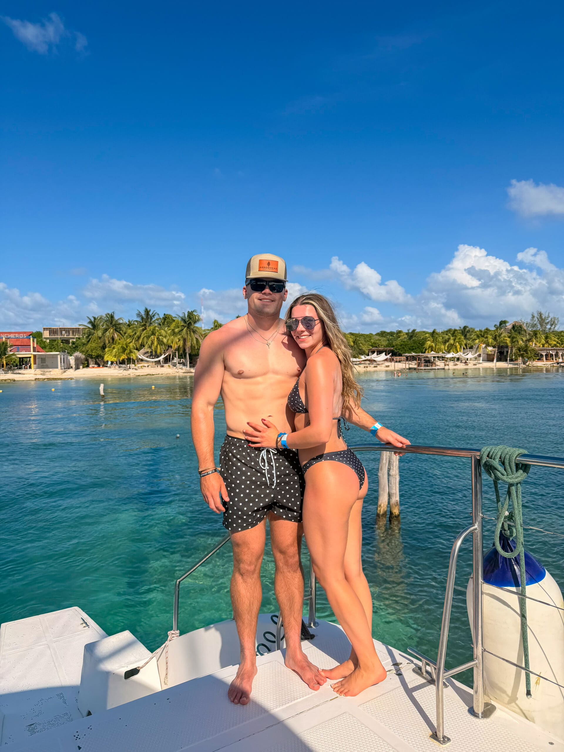 Posing on catamaran docked at Isla Mujeres during Haven Riviera Cancun honeymoon