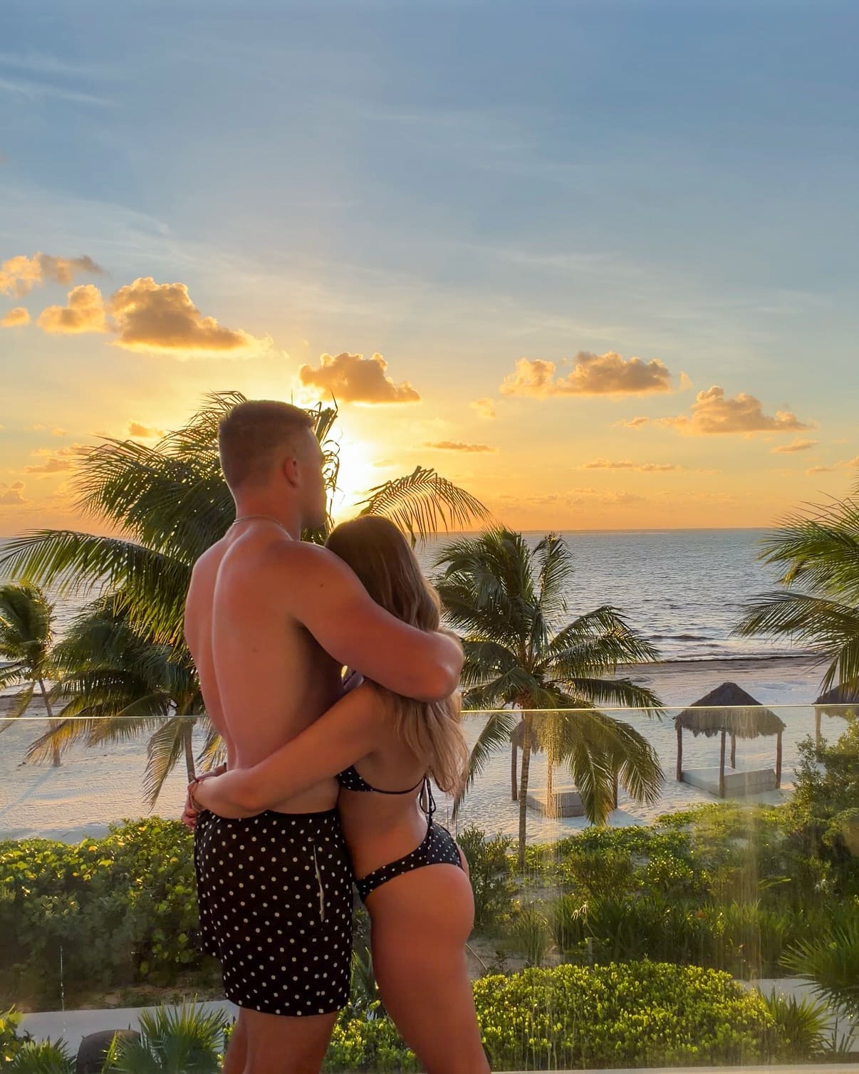 Watching sunrise with husband on our private balcony at Haven Riviera Cancun