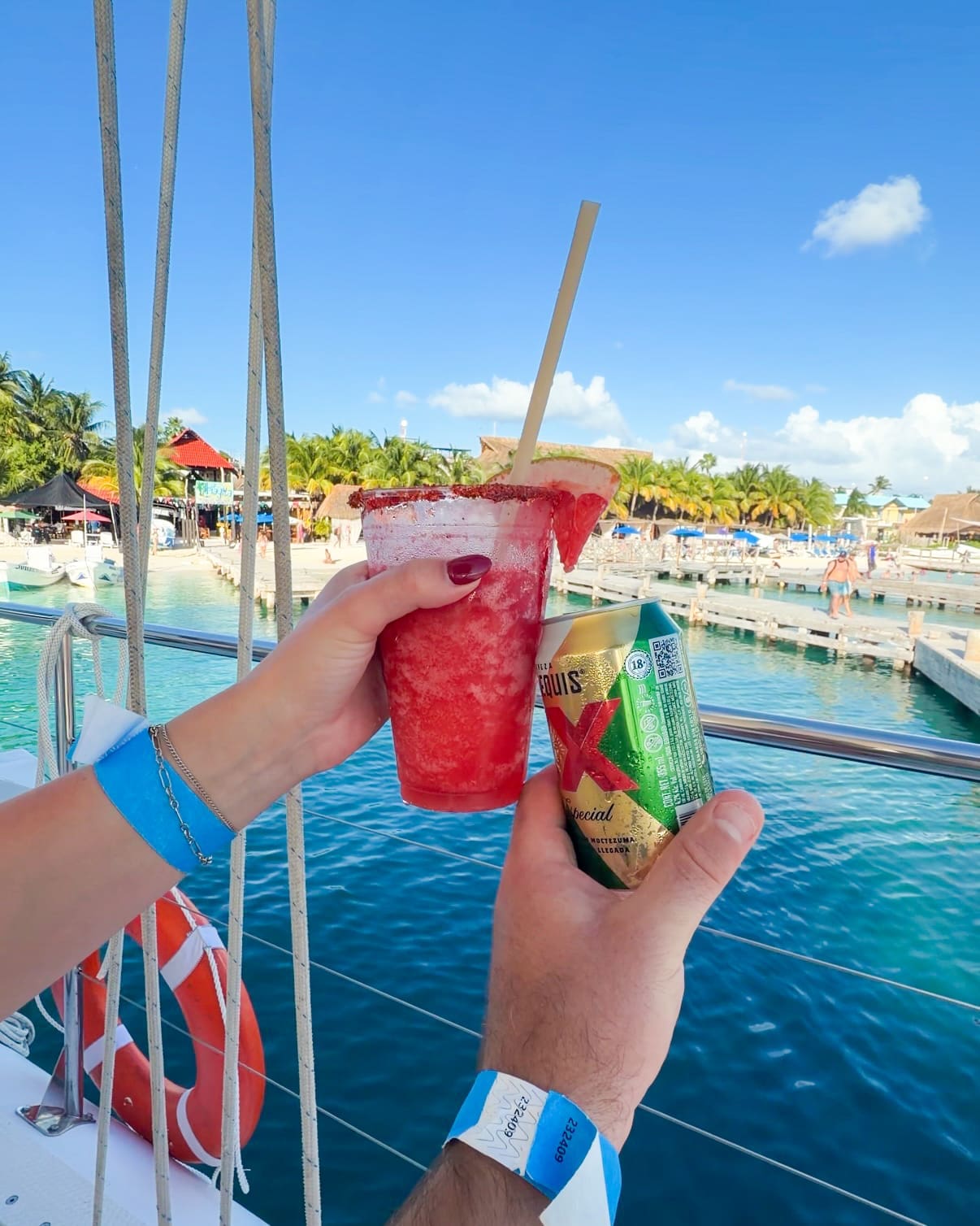 Clinking drinks together on the catamaran during Mexico Travel Solutions excursion