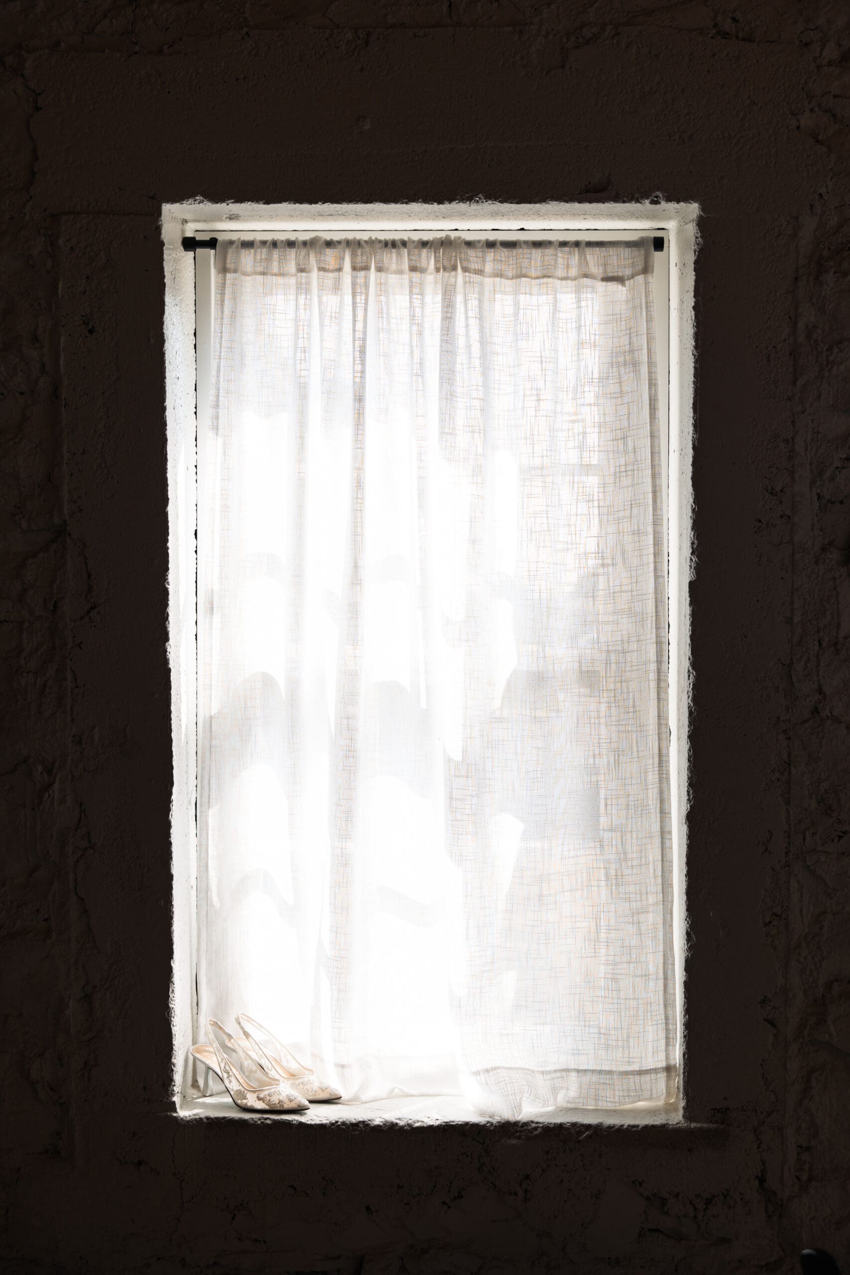 Soft natural light filtering through sheer curtains at Stone Manor on 79th, creating a cozy and timeless wedding morning atmosphere.