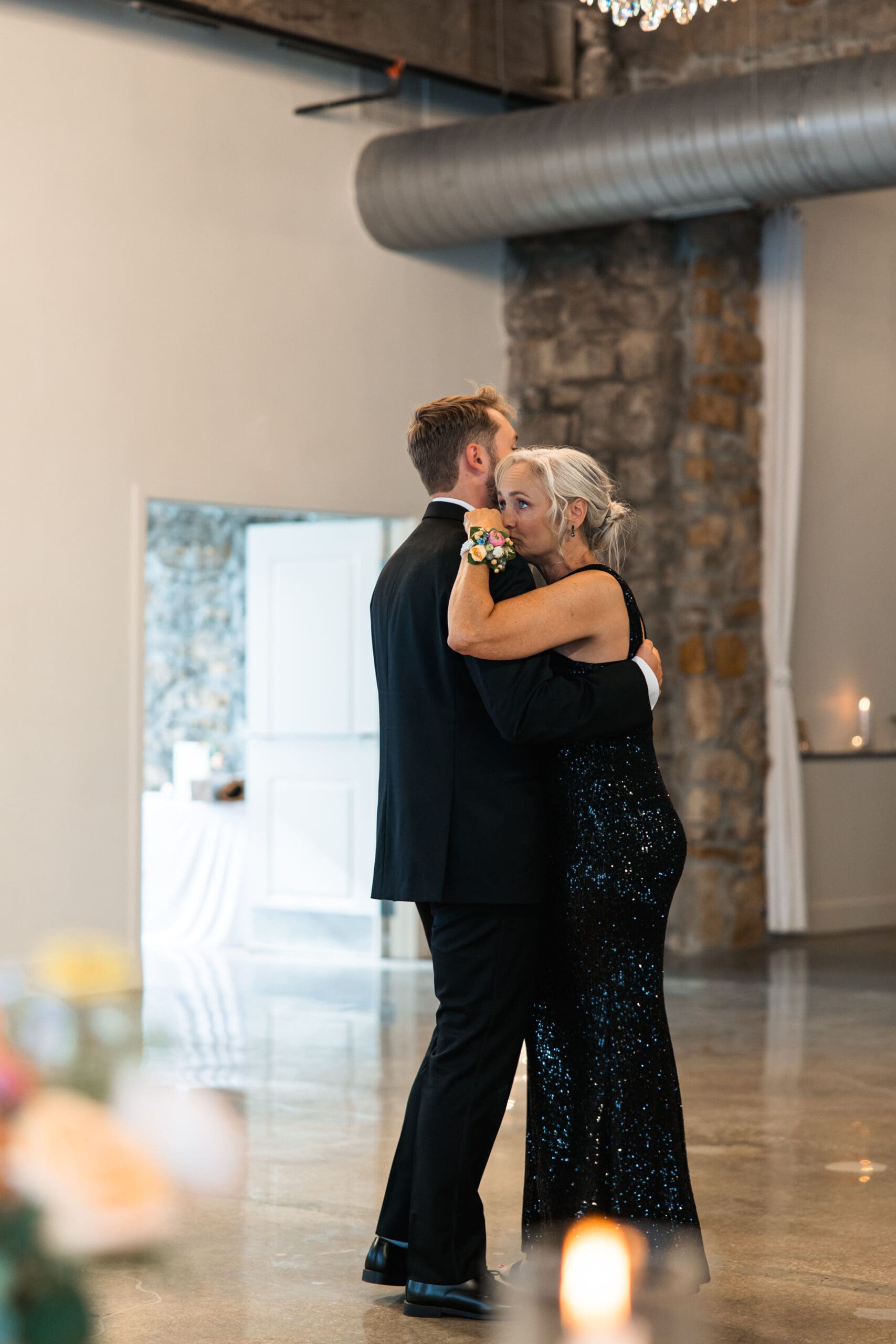 Groom shares a heartfelt dance with his mother during the wedding reception at Stone Manor on 79th in Overland Park, Kansas.