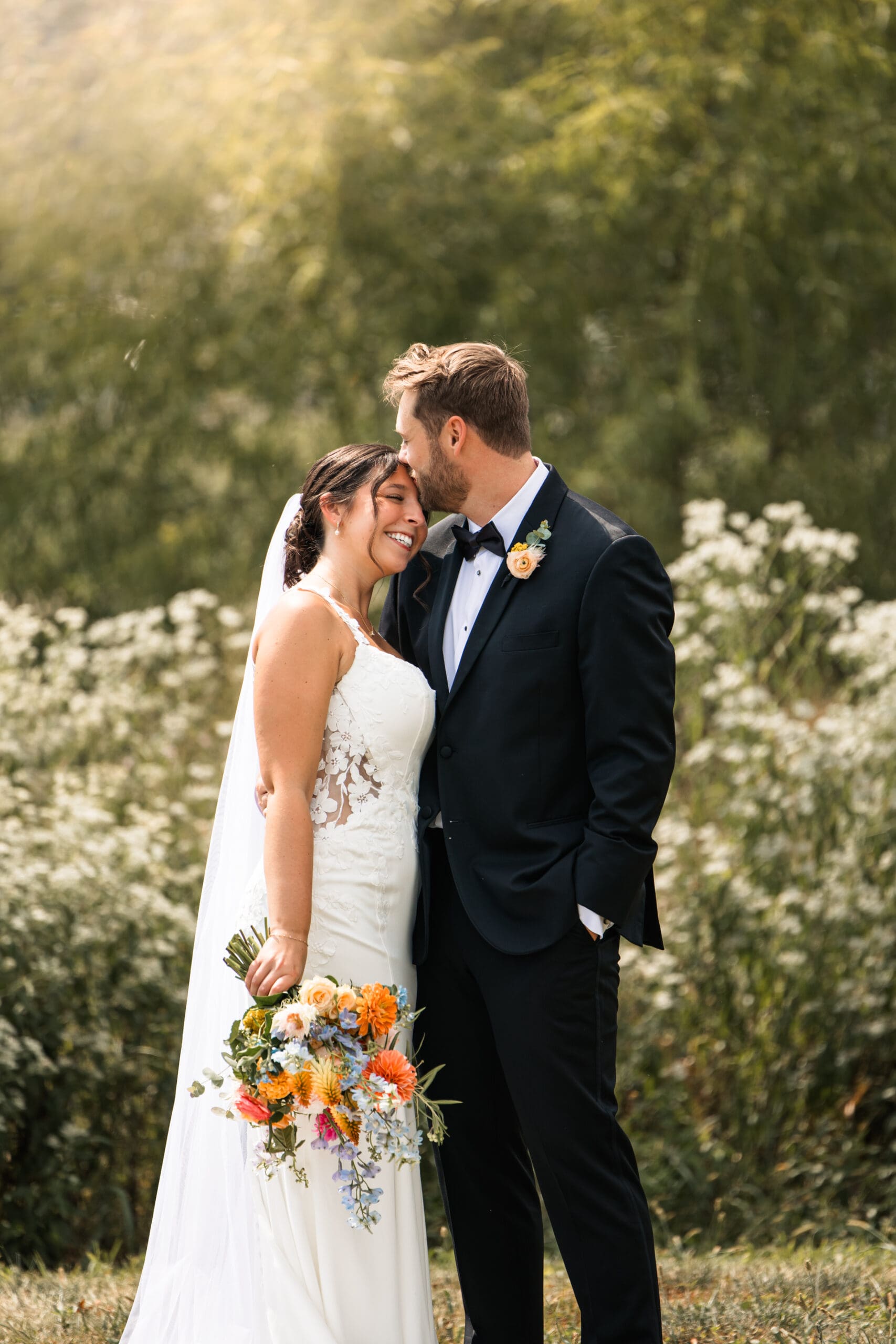 Intimate bride and groom portrait surrounded by wildflowers at Meadowbrook Park in Overland Park, captured by Kansas wedding photographer Briana Jewell Photography