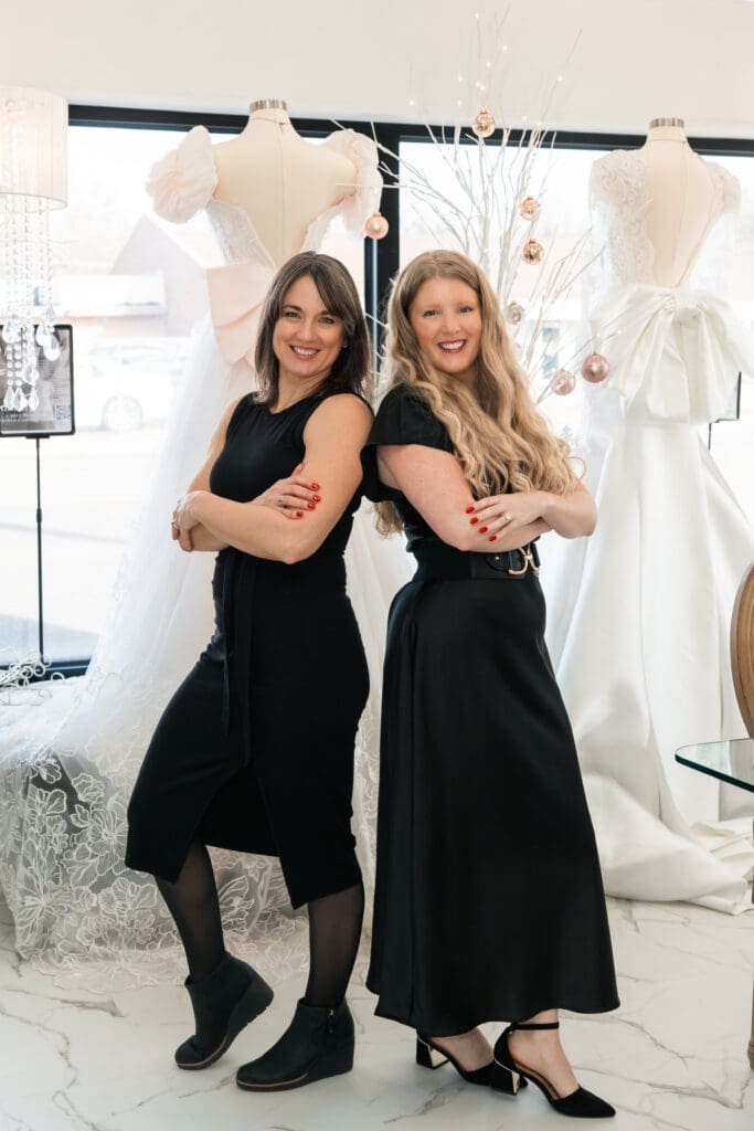 Vanya Designs designers surrounded by custom wedding gowns in their Wichita bridal atelier