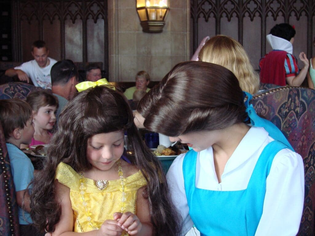Nostalgic childhood Disney memory: young girl in Belle costume meeting Belle at Cinderella’s Castle restaurant – inspiring return to Disney World Orlando as an adult