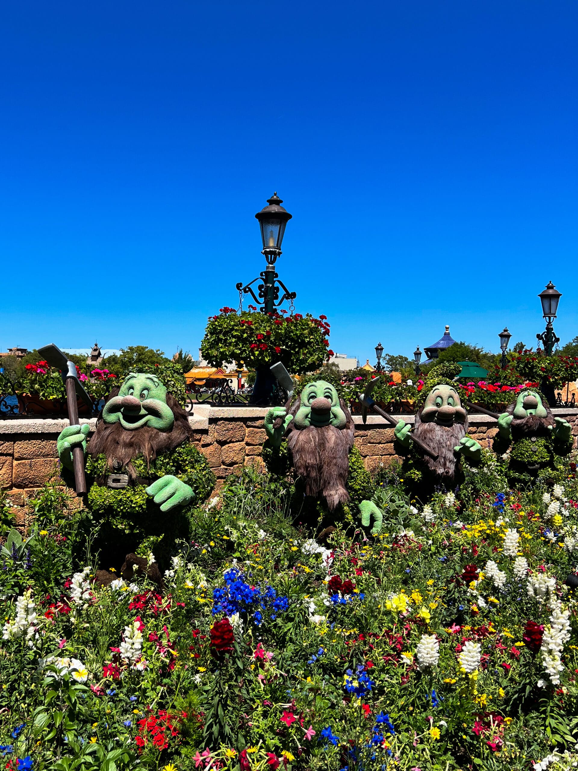 Doc, Grumpy, Happy, Sleepy, Bashful, Sneezy, and Dopey topiary figures from Snow White at Epcot Flower & Garden Festival Disney World – adorable Disney character topiaries in Orlando
