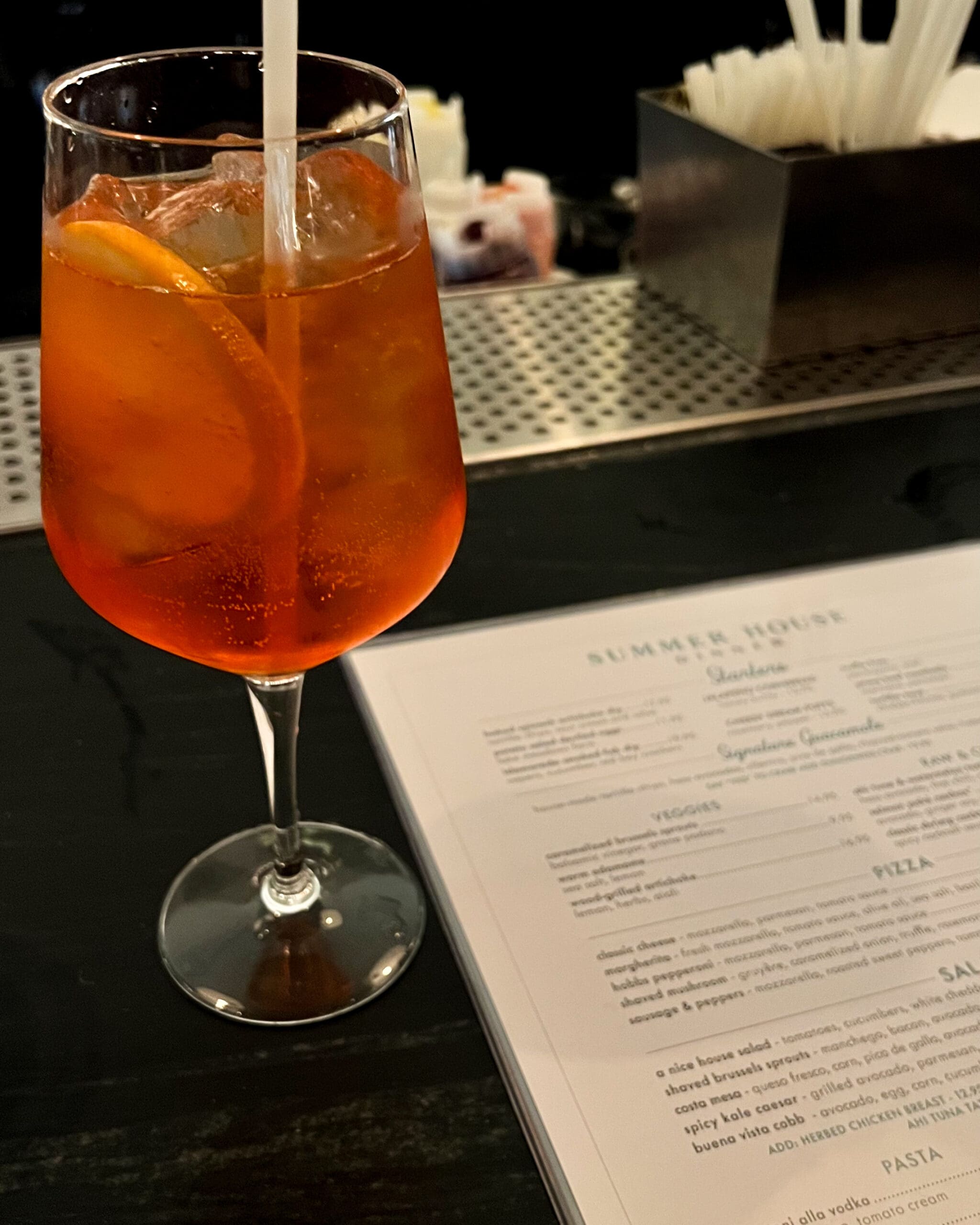 Bright orange Aperol Spritz cocktail with orange slice at Summer House on the Lake bar Disney Springs – refreshing drink after Leu Gardens Ave & Liv styled shoot