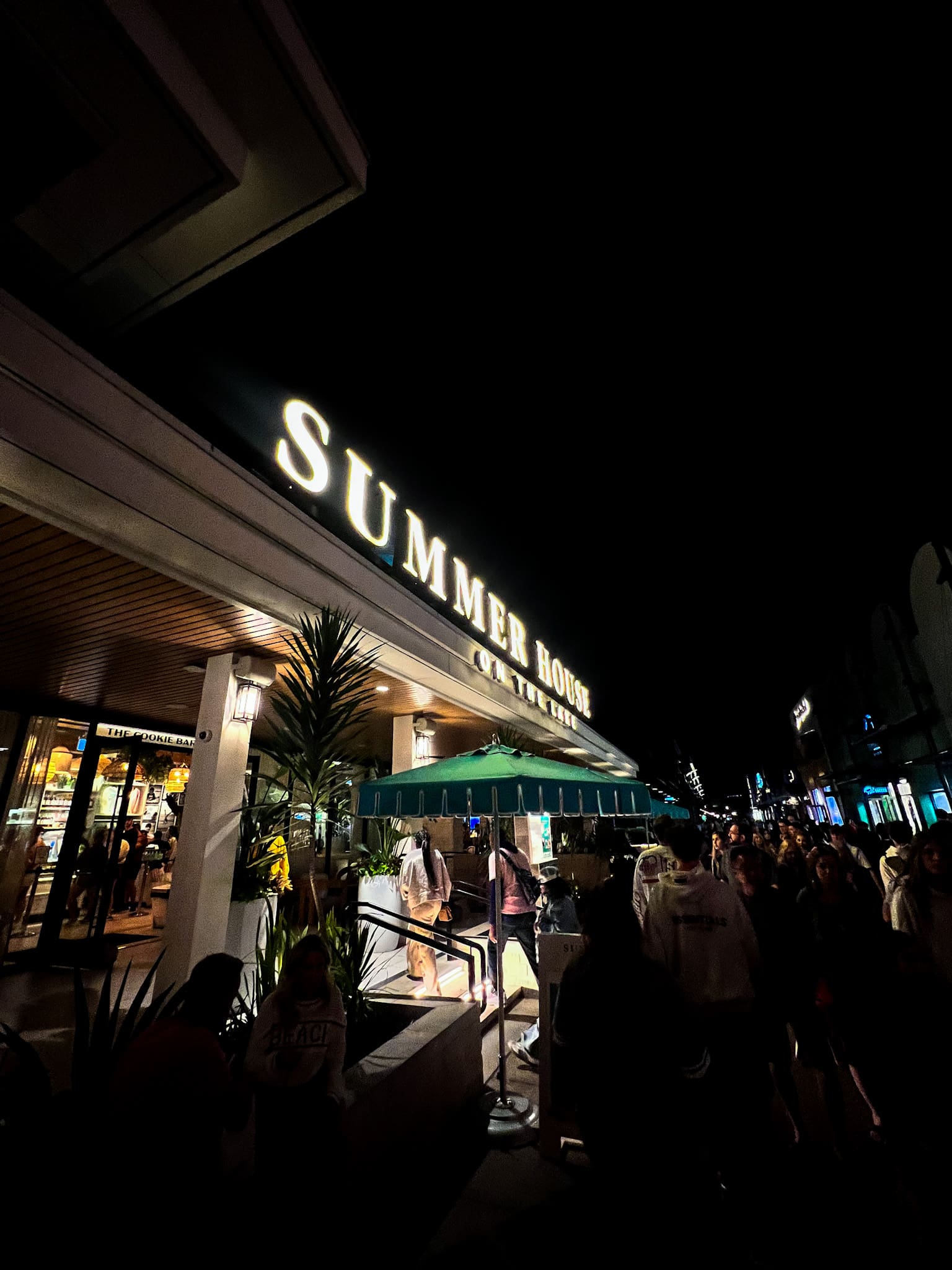 Glowing Summer House on the Lake sign at Disney Springs Orlando at night – dinner destination after Leu Gardens styled session with Ave & Liv collection