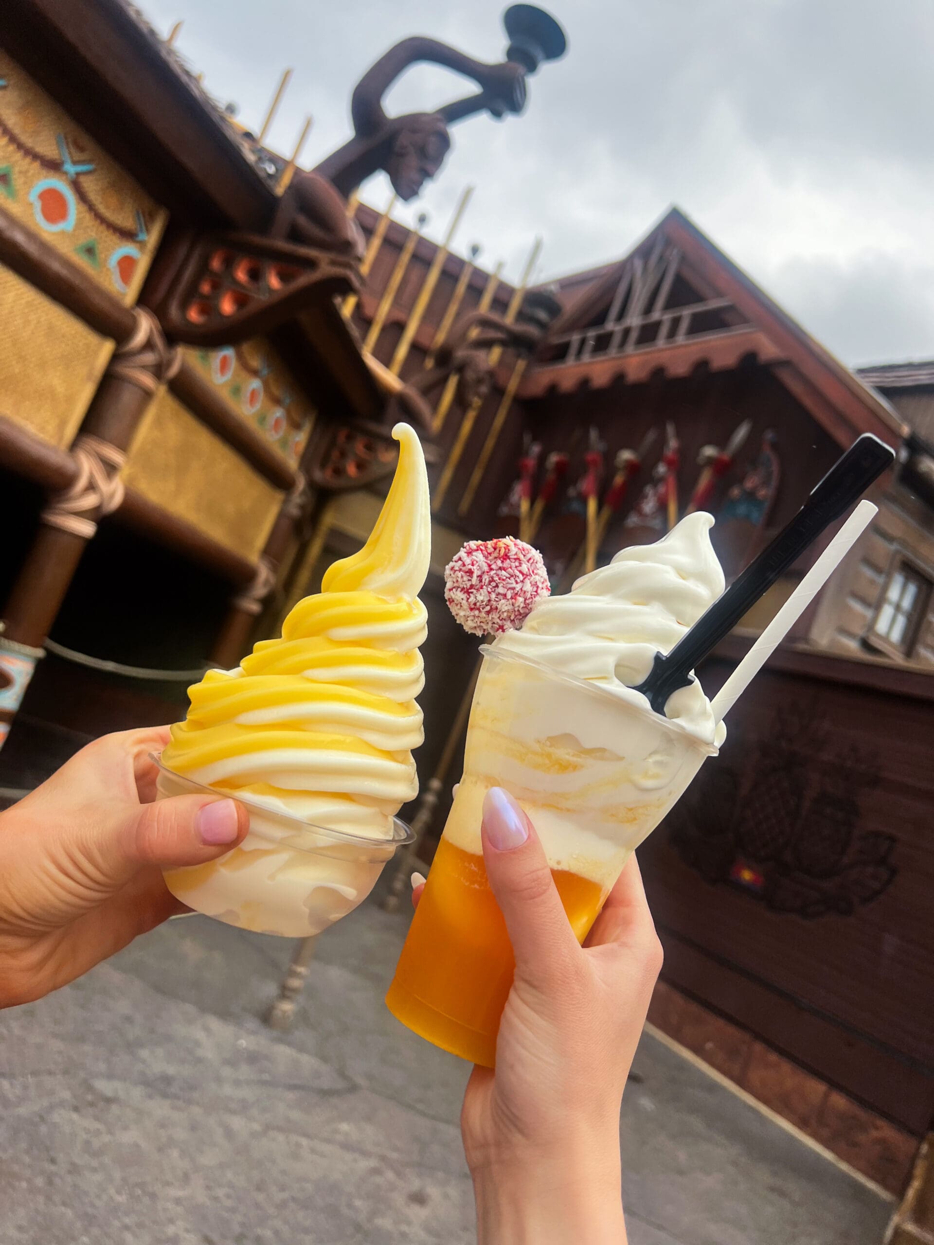Swirled yellow pineapple soft-serve and orange Dole Whip float at Magic Kingdom Disney World – delicious frozen treats during enchanting Orlando Disney day