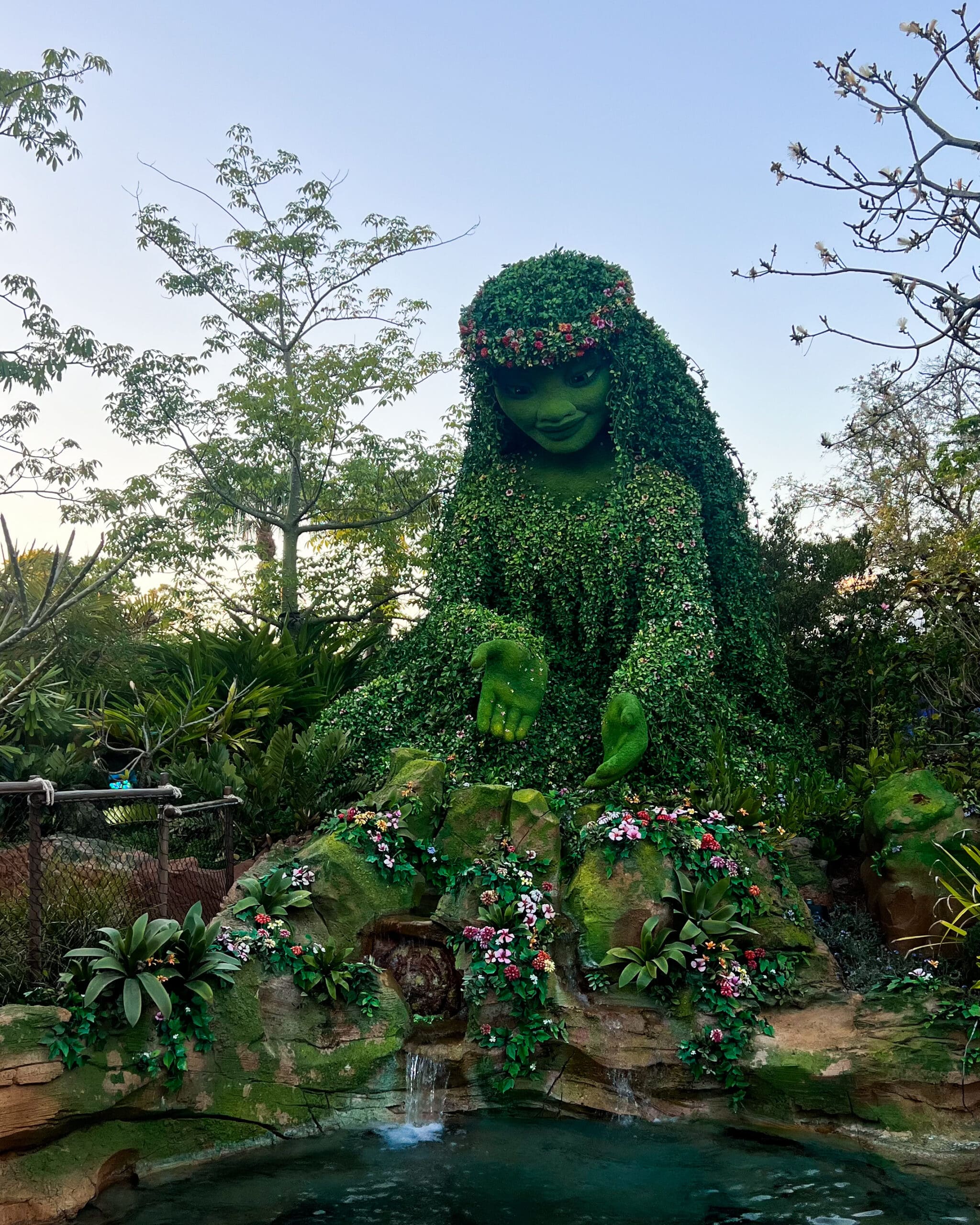 Moana and Maui topiary characters surrounded by flowers at Epcot International Flower & Garden Festival Disney World – colorful Disney topiary magic in Orlando