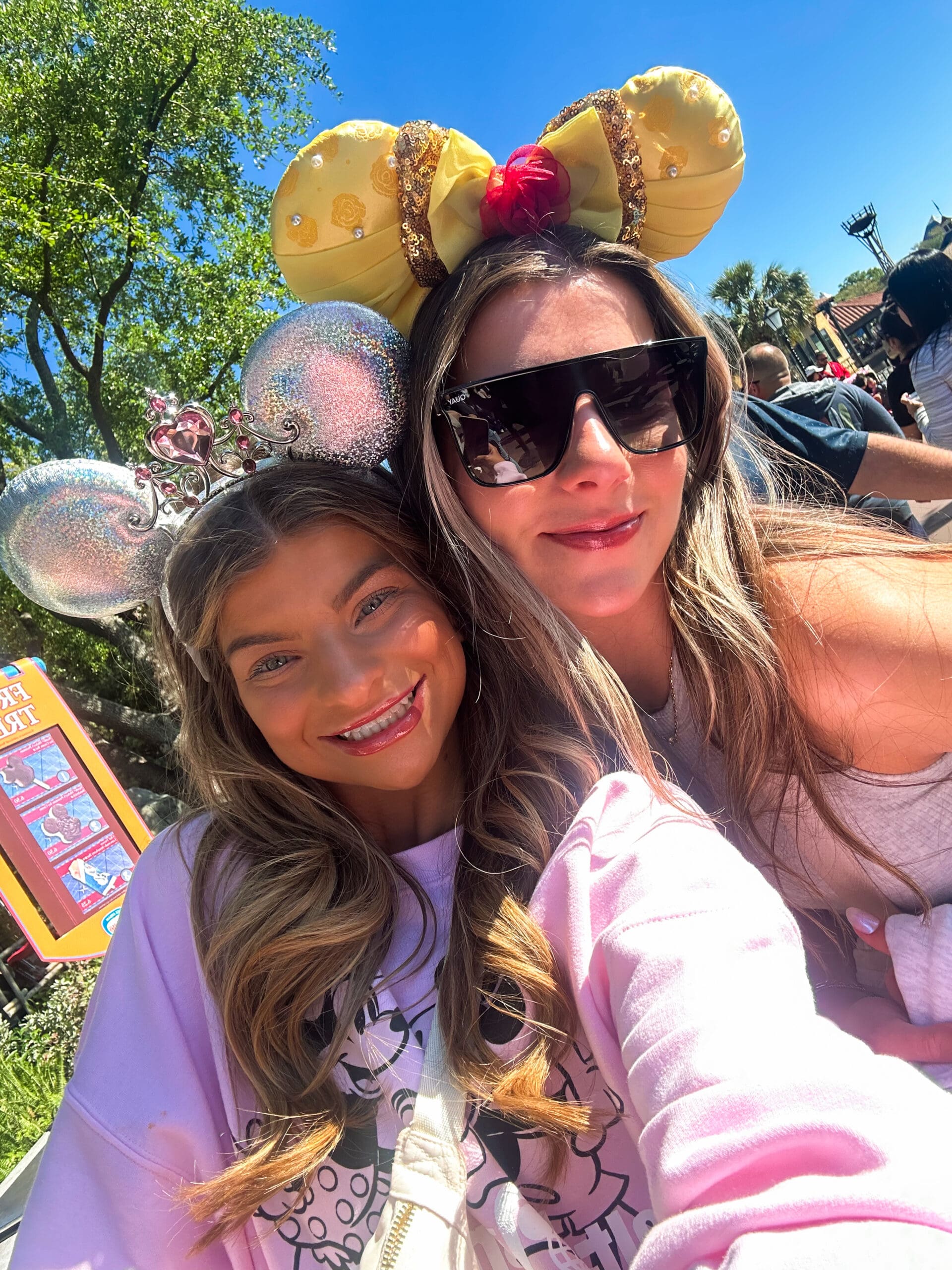 Two friends smiling in sparkling Minnie Mouse ears in front of Cinderella Castle at Magic Kingdom Disney World – joyful Disney moments captured in Orlando